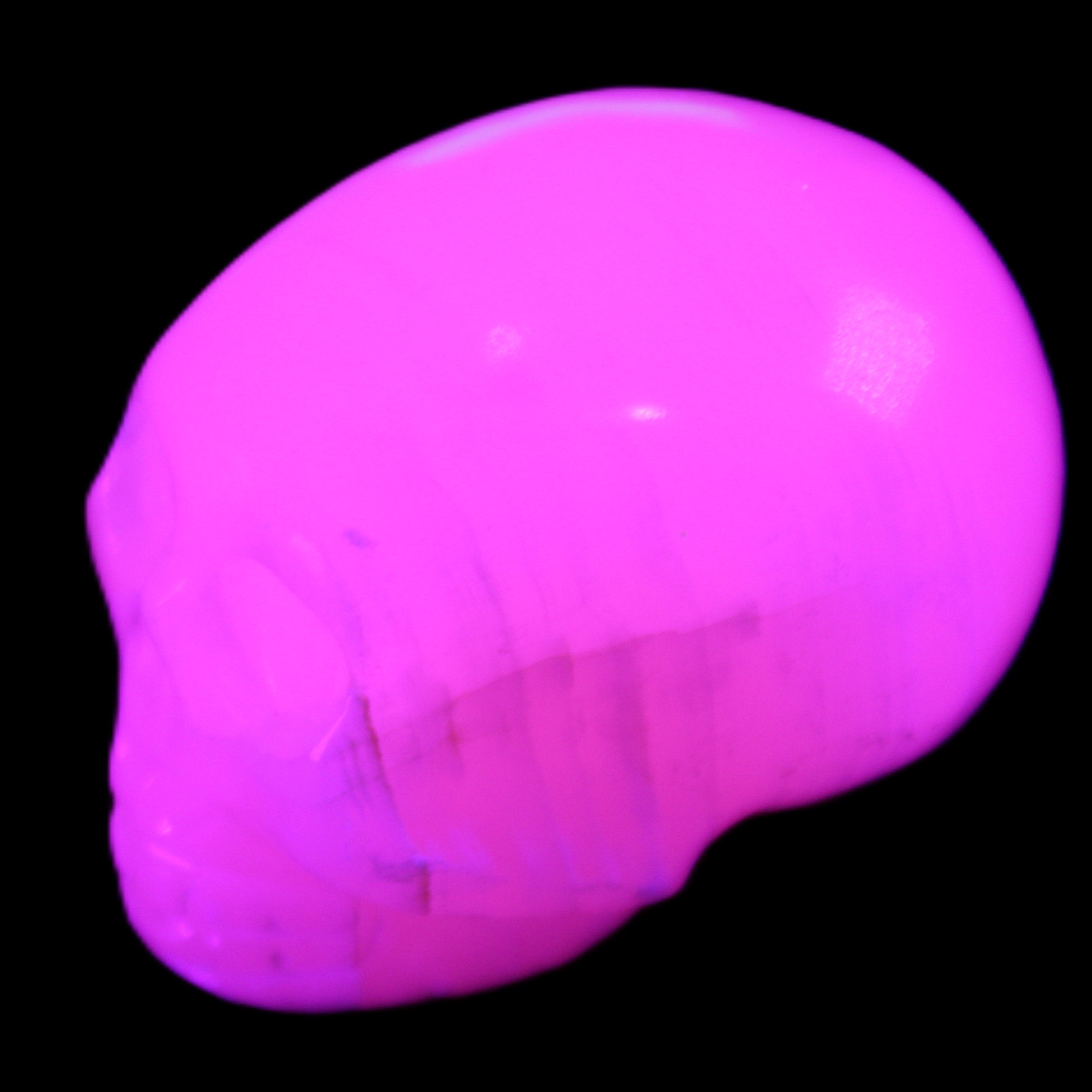 Mangano Calcite skull 30*47*35mm 81g in UV light - Rocks and Things Store