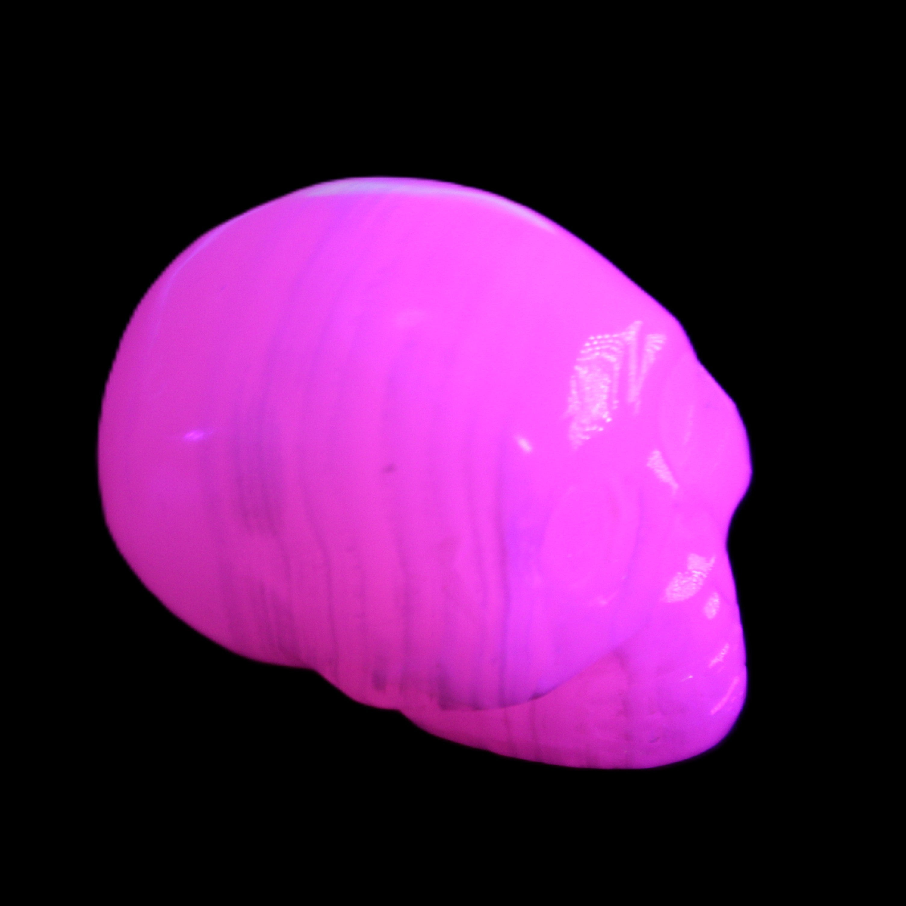 Mangano Calcite skull 30*47*35mm 81g in UV light - Rocks and Things Store
