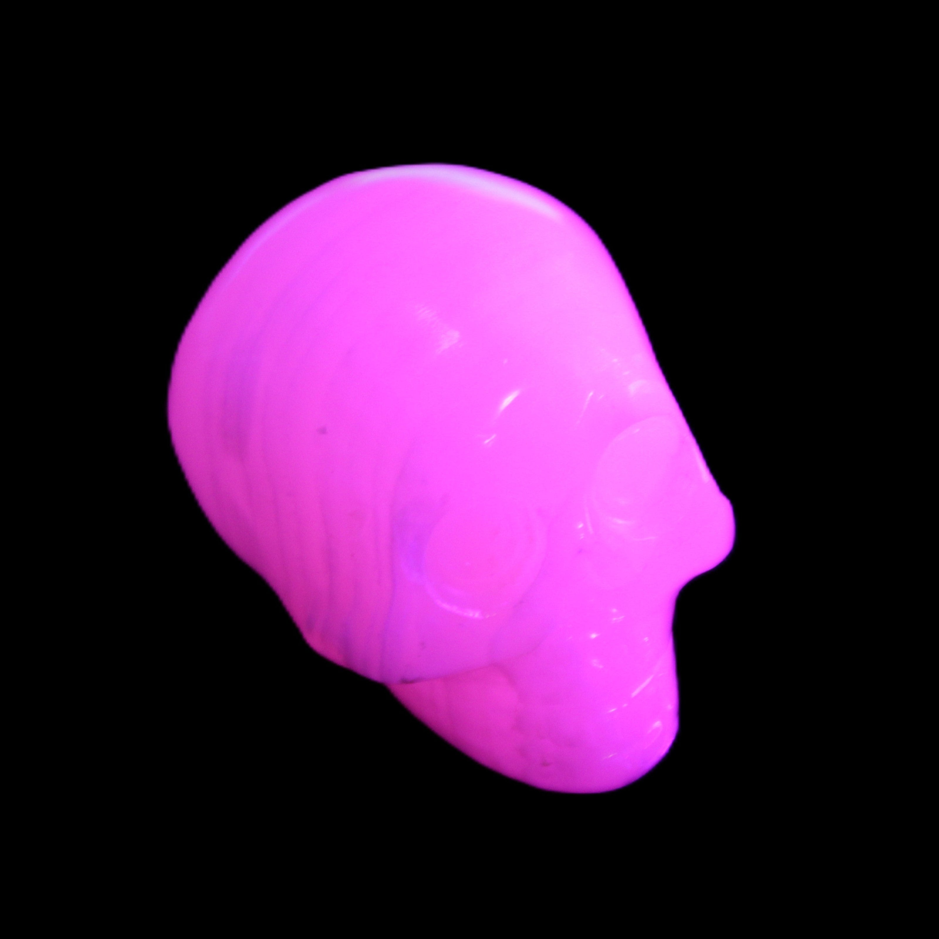 Mangano Calcite skull 30*47*35mm 81g in UV light - Rocks and Things Store