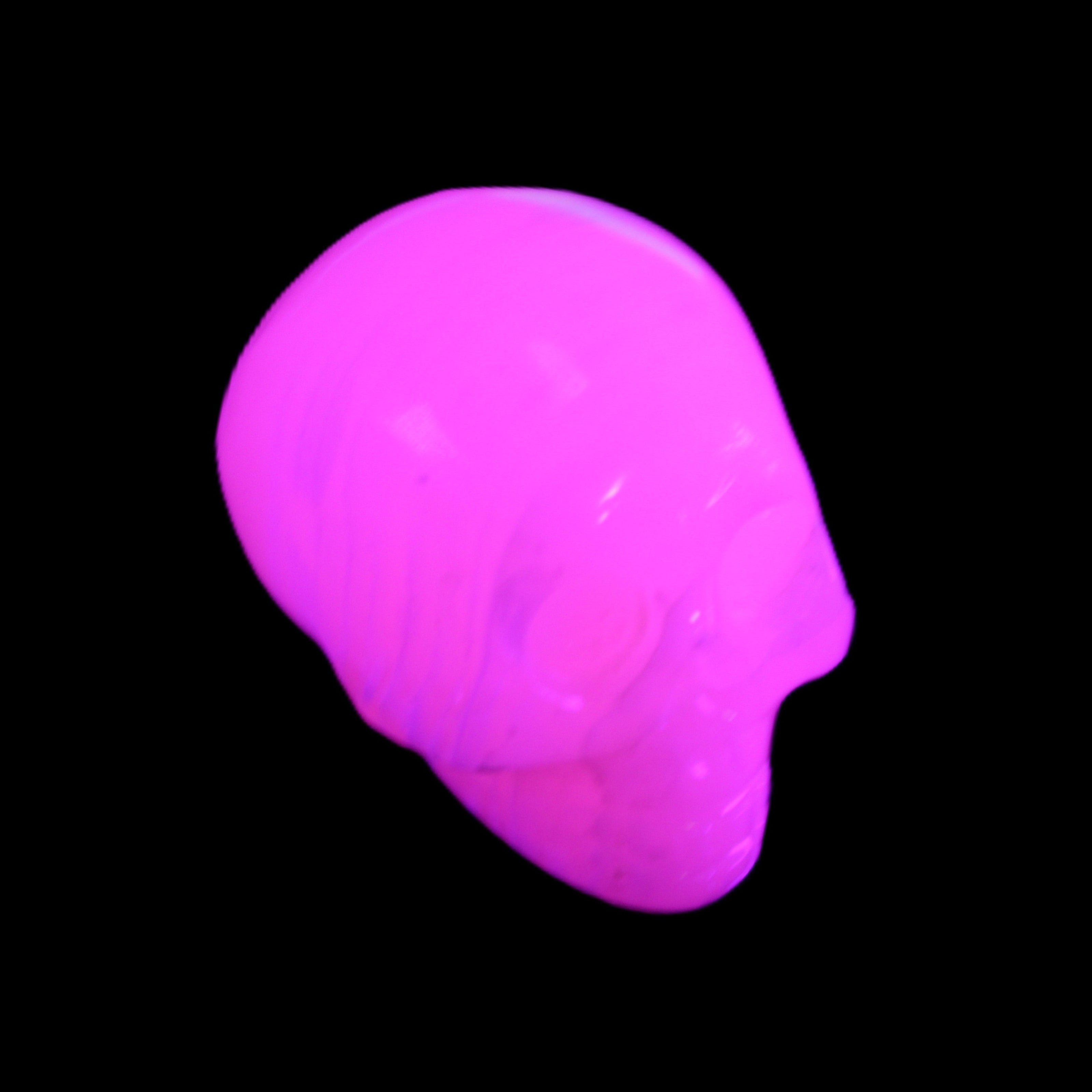 Mangano Calcite skull 30*47*35mm 81g in UV light - Rocks and Things Store