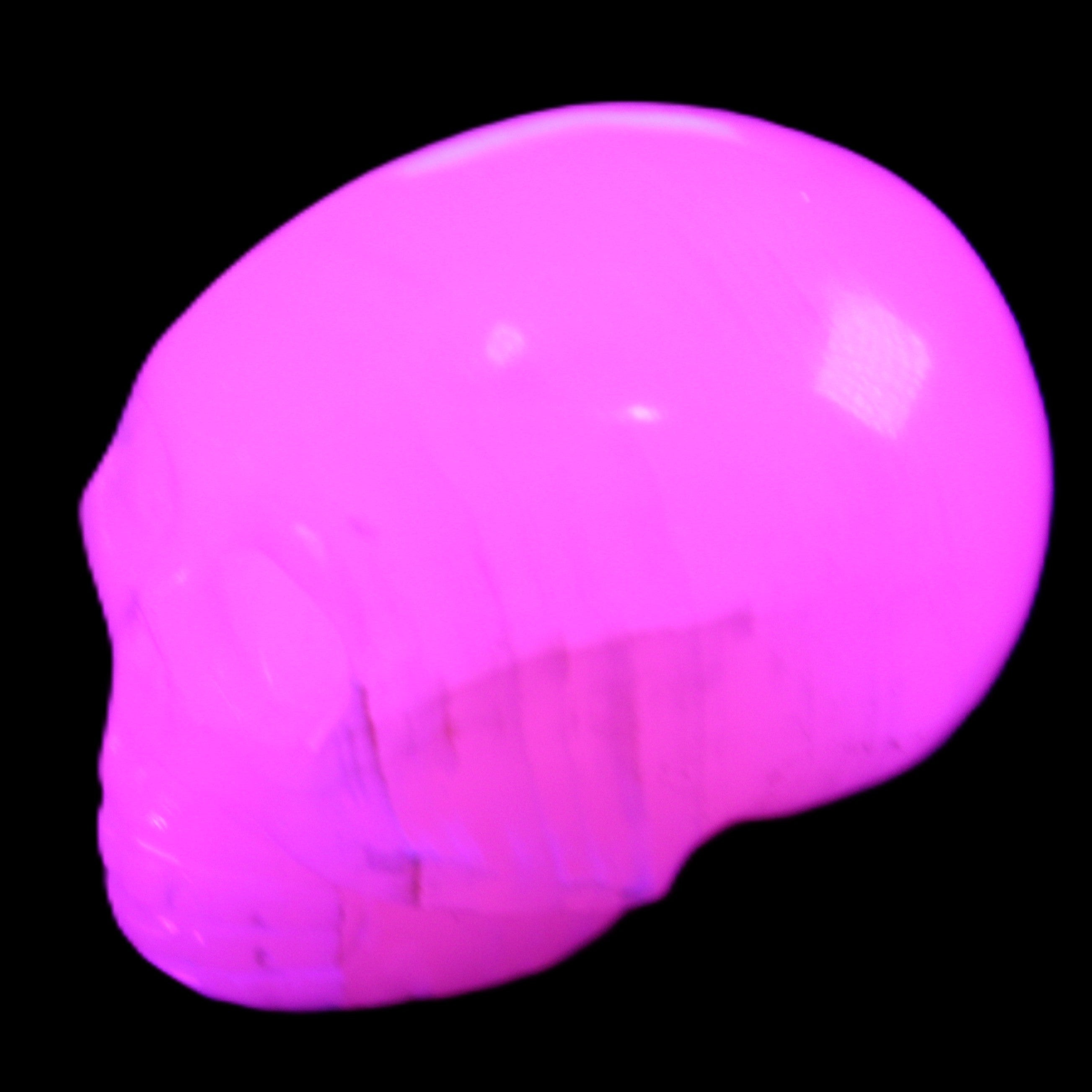 Mangano Calcite skull 30*47*35mm 81g in UV light - Rocks and Things Store