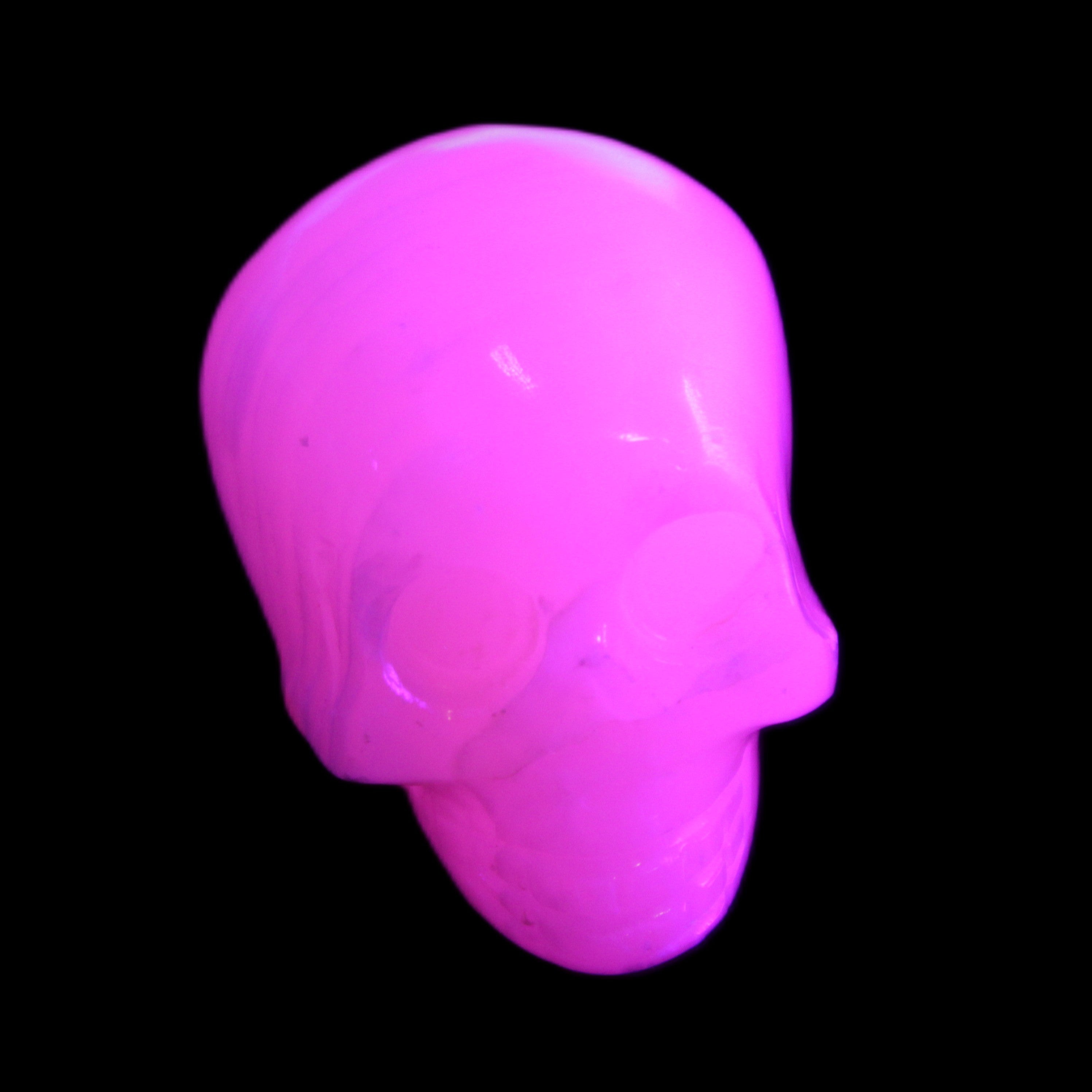 Mangano Calcite skull 30*47*35mm 81g in UV light - Rocks and Things Store