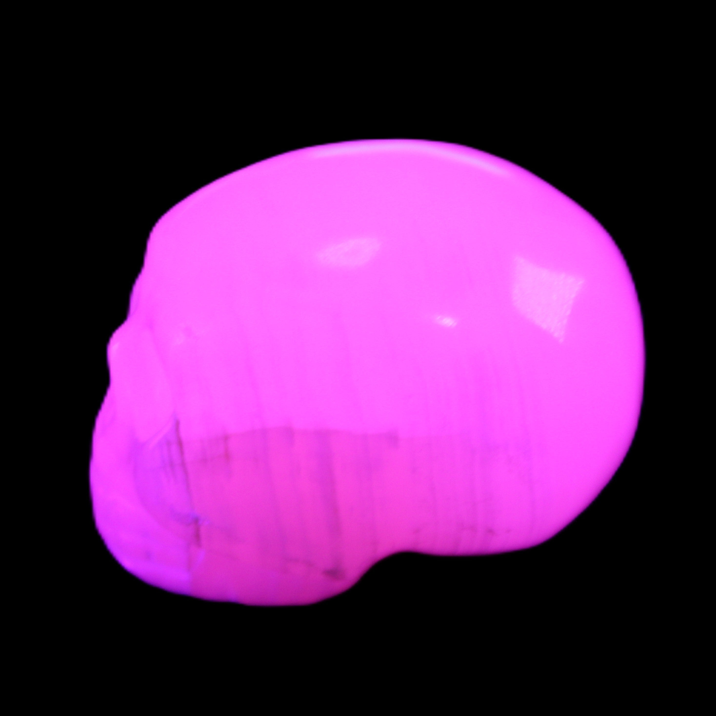 Mangano Calcite skull 30*47*35mm 81g in UV light - Rocks and Things Store