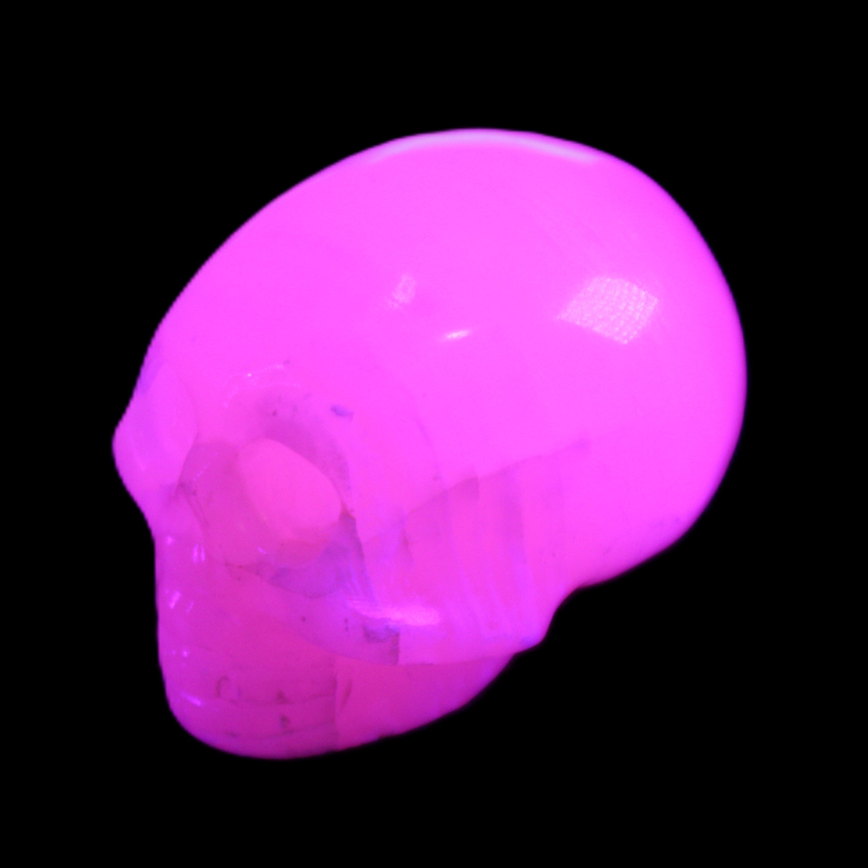 Mangano Calcite skull 30*47*35mm 81g in UV light - Rocks and Things Store