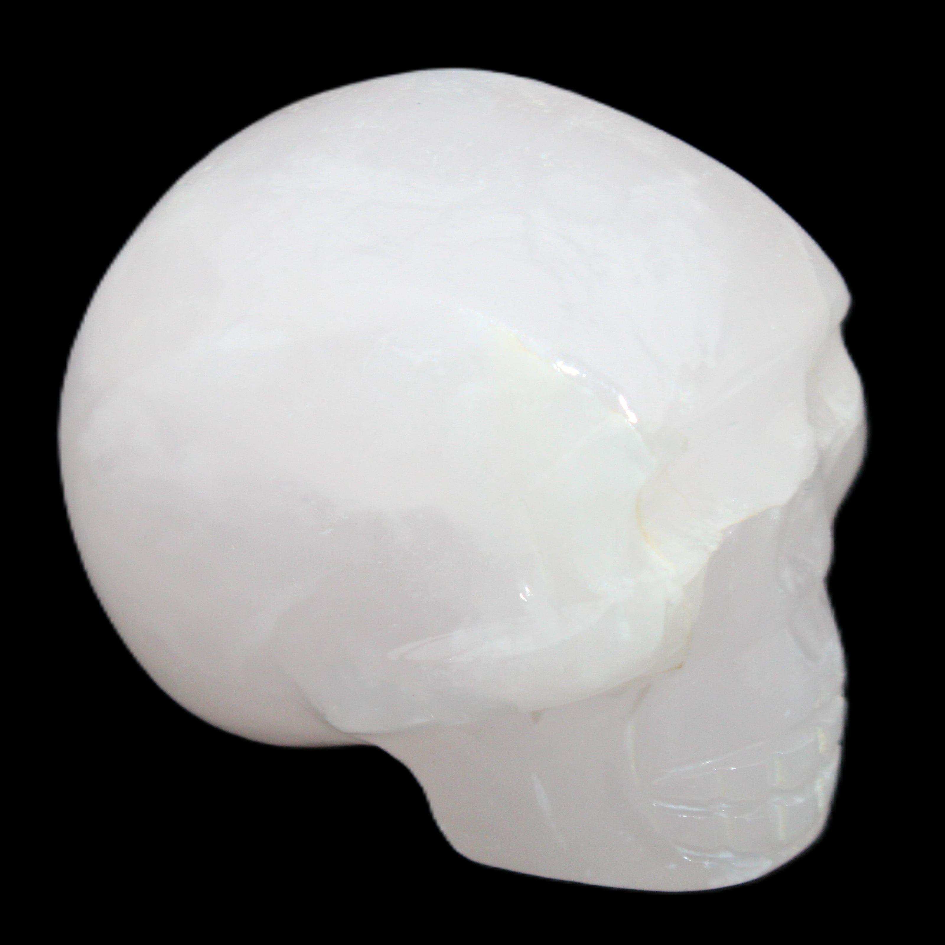 Mangano Calcite skull 45*60*57mm 199g in sunlight - Rocks and Things Store