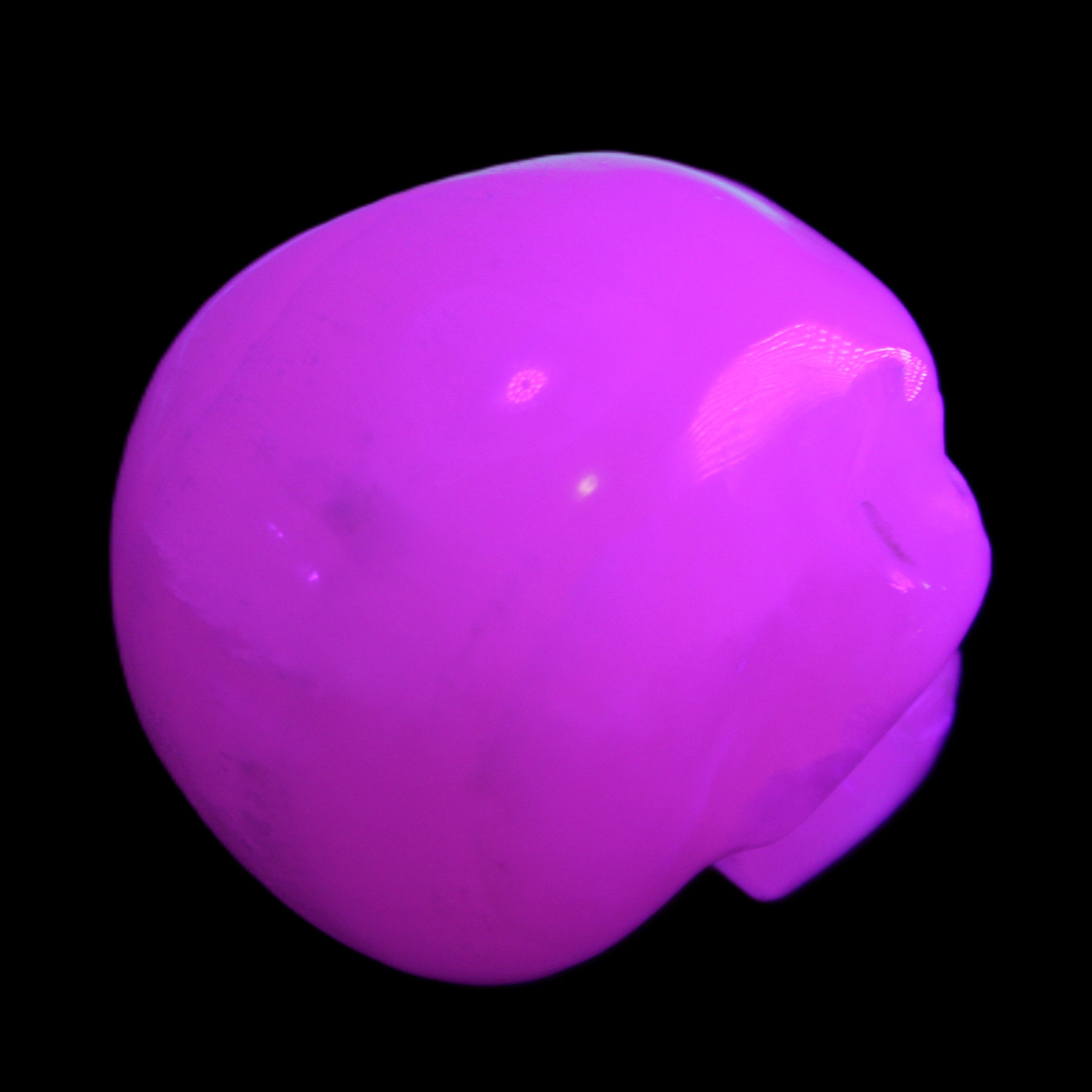 Mangano Calcite skull 45*60*57mm 199g in UV light - Rocks and Things Store