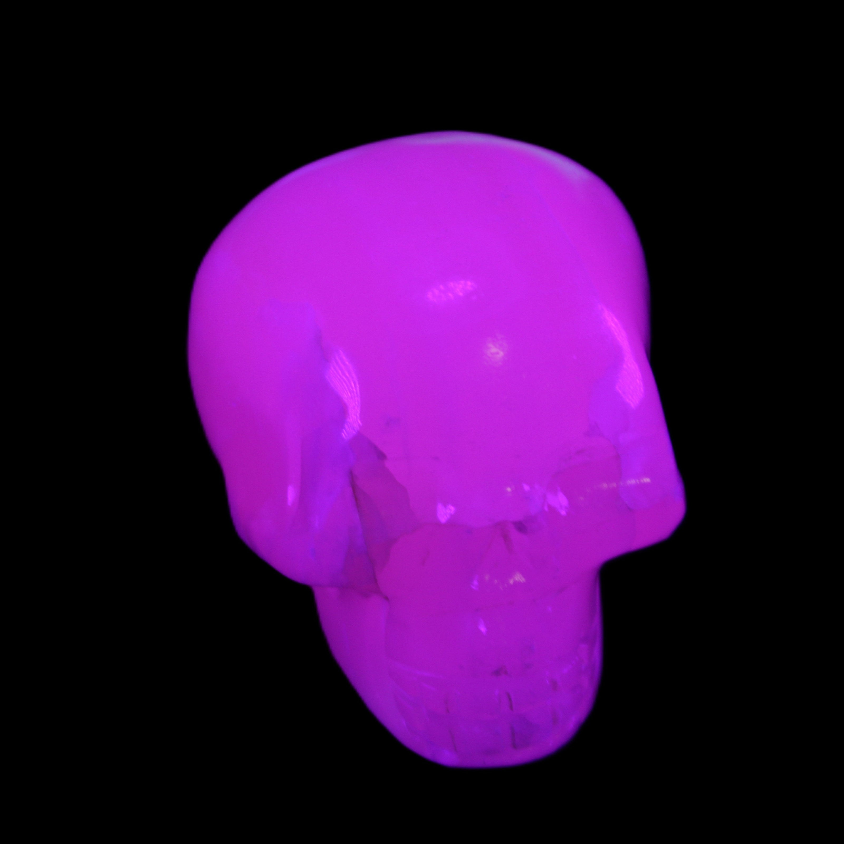 Mangano Calcite skull 45*60*57mm 199g in UV light - Rocks and Things Store