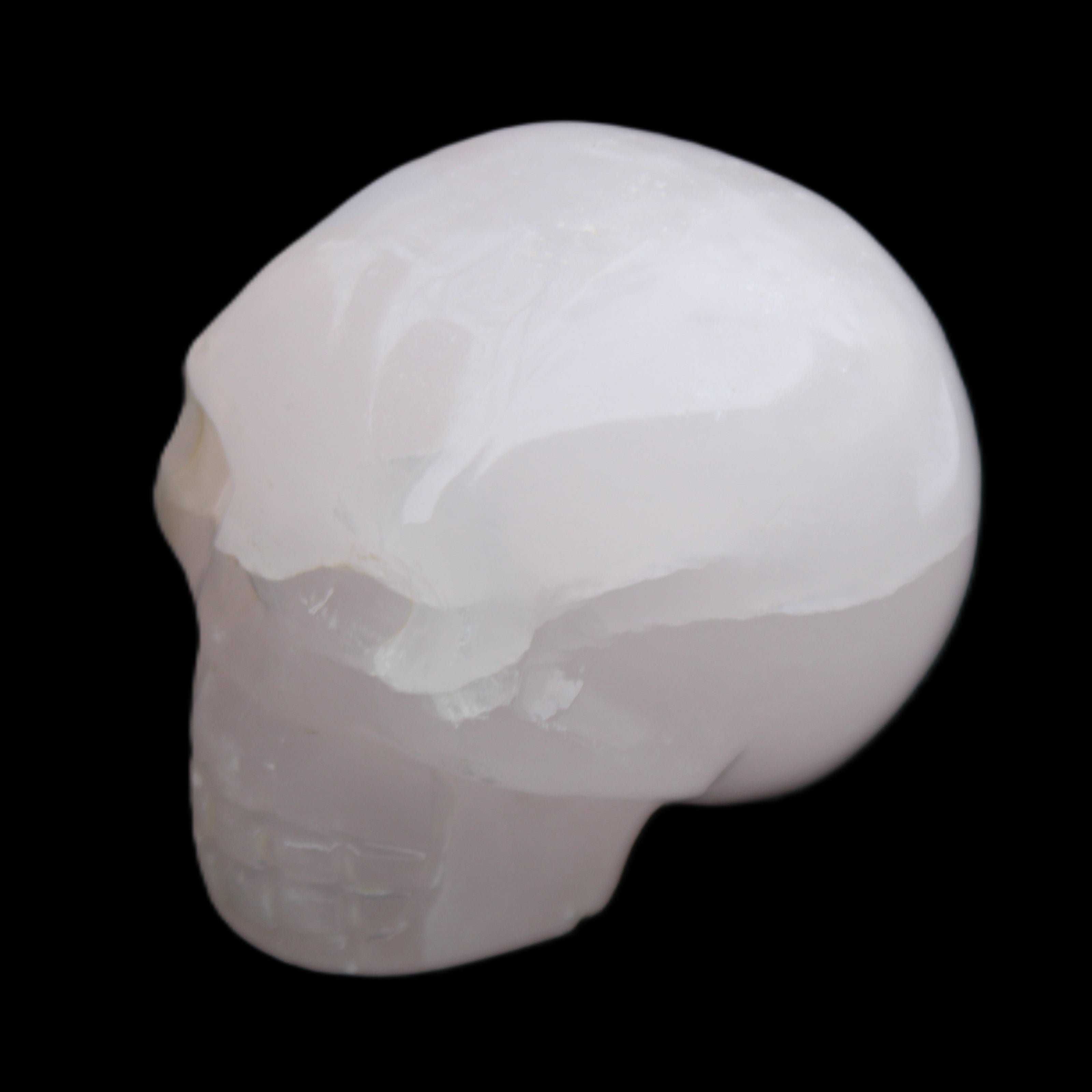 Mangano Calcite skull 45*60*57mm 199g in sunlight - Rocks and Things Store