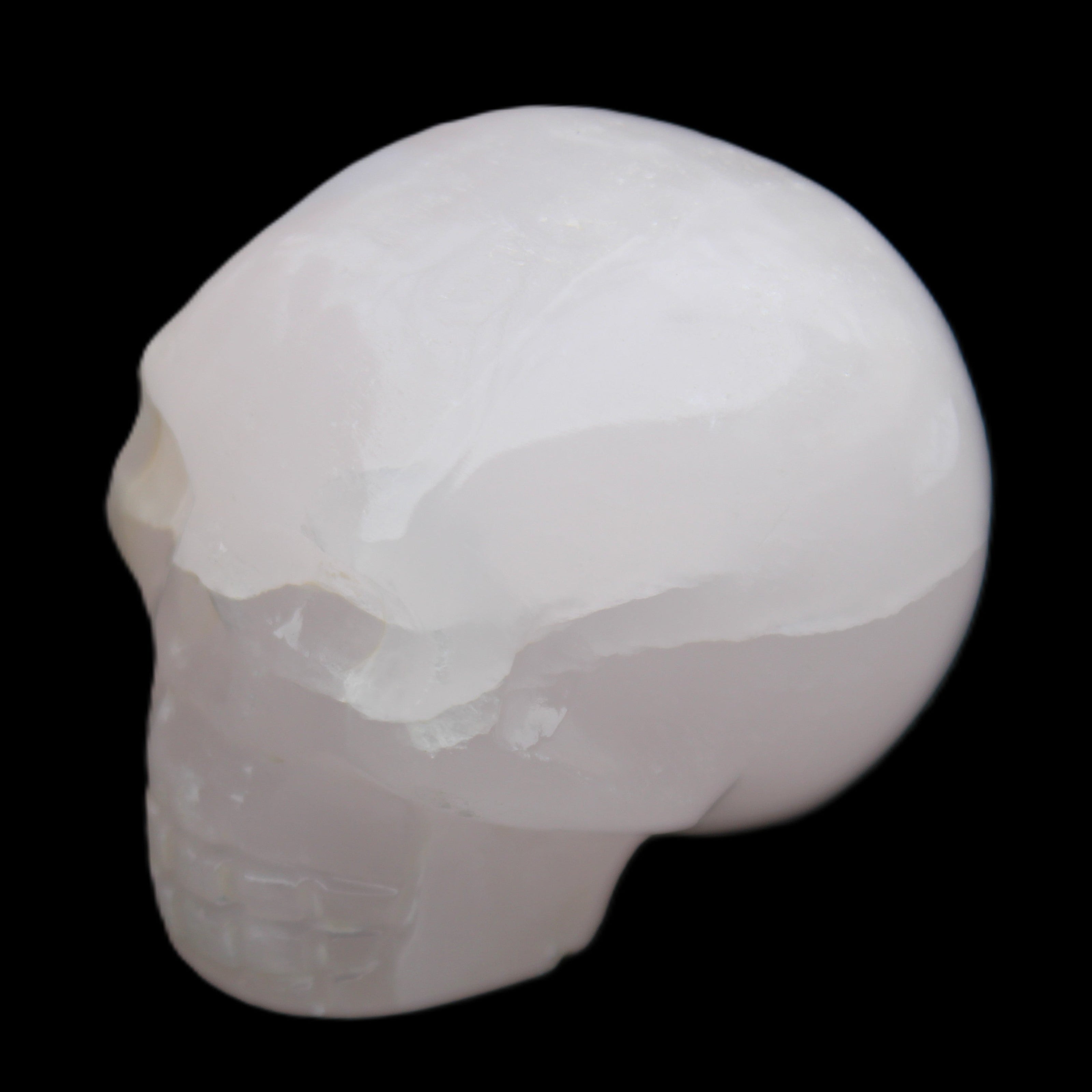 Mangano Calcite skull 45*60*57mm 199g in sunlight - Rocks and Things Store
