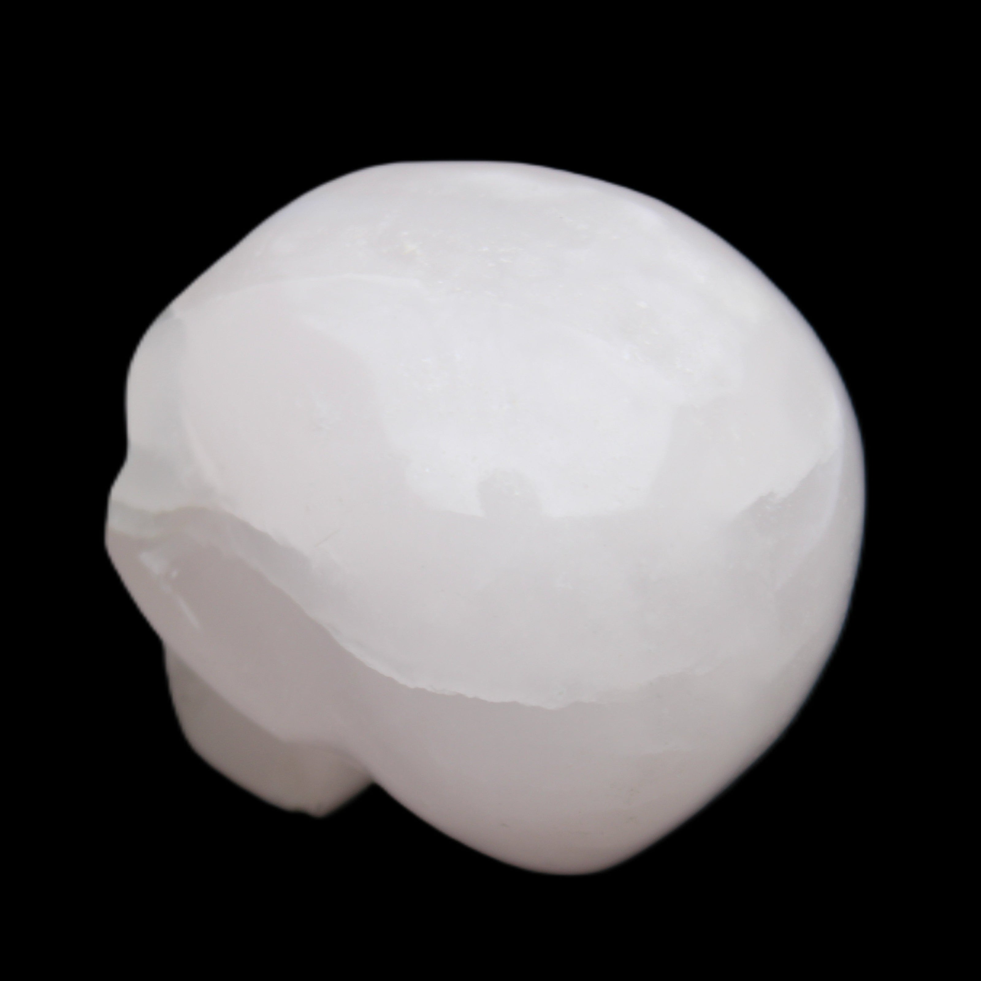Mangano Calcite skull 45*60*57mm 199g in sunlight - Rocks and Things Store