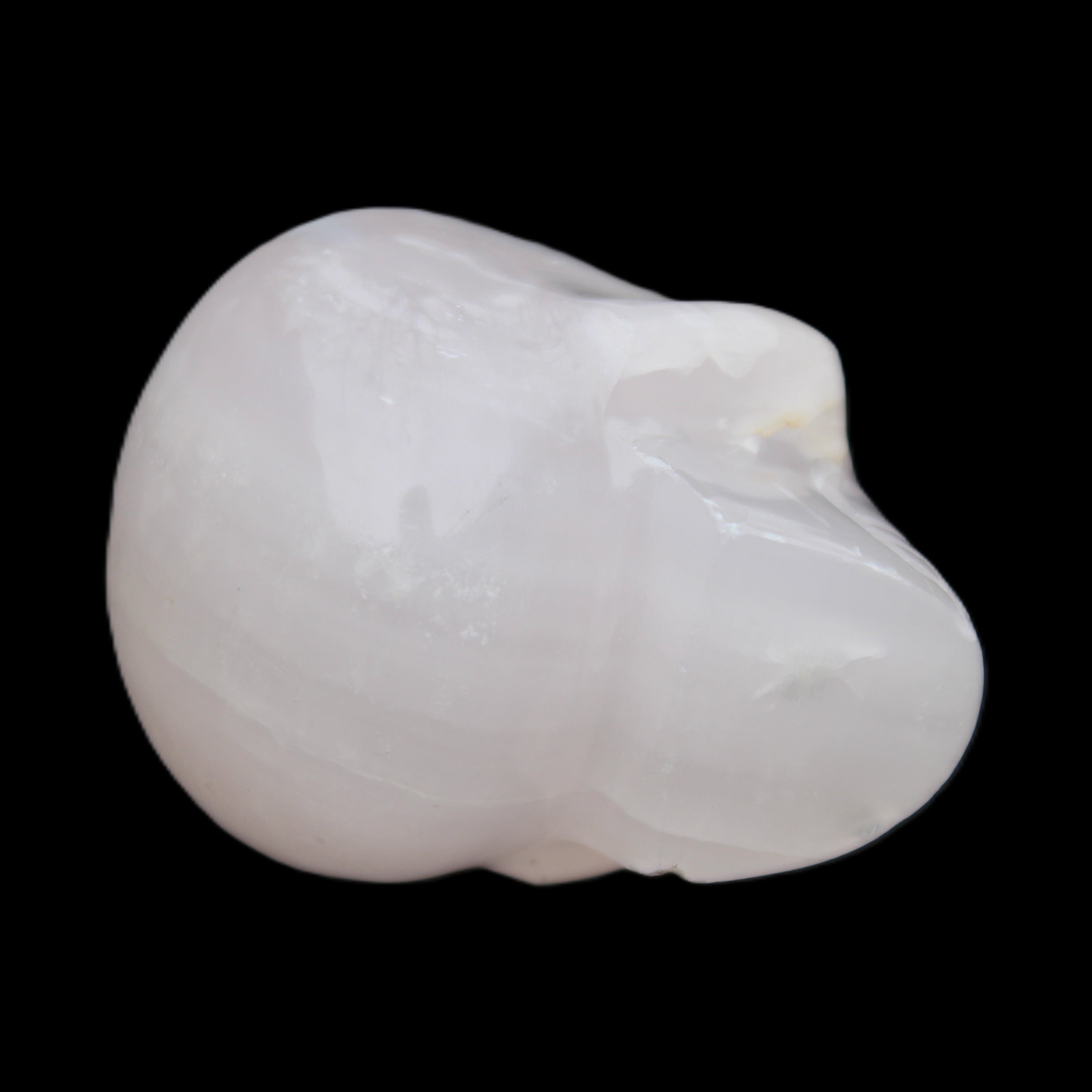 Mangano Calcite skull 45*60*57mm 199g in sunlight - Rocks and Things Store