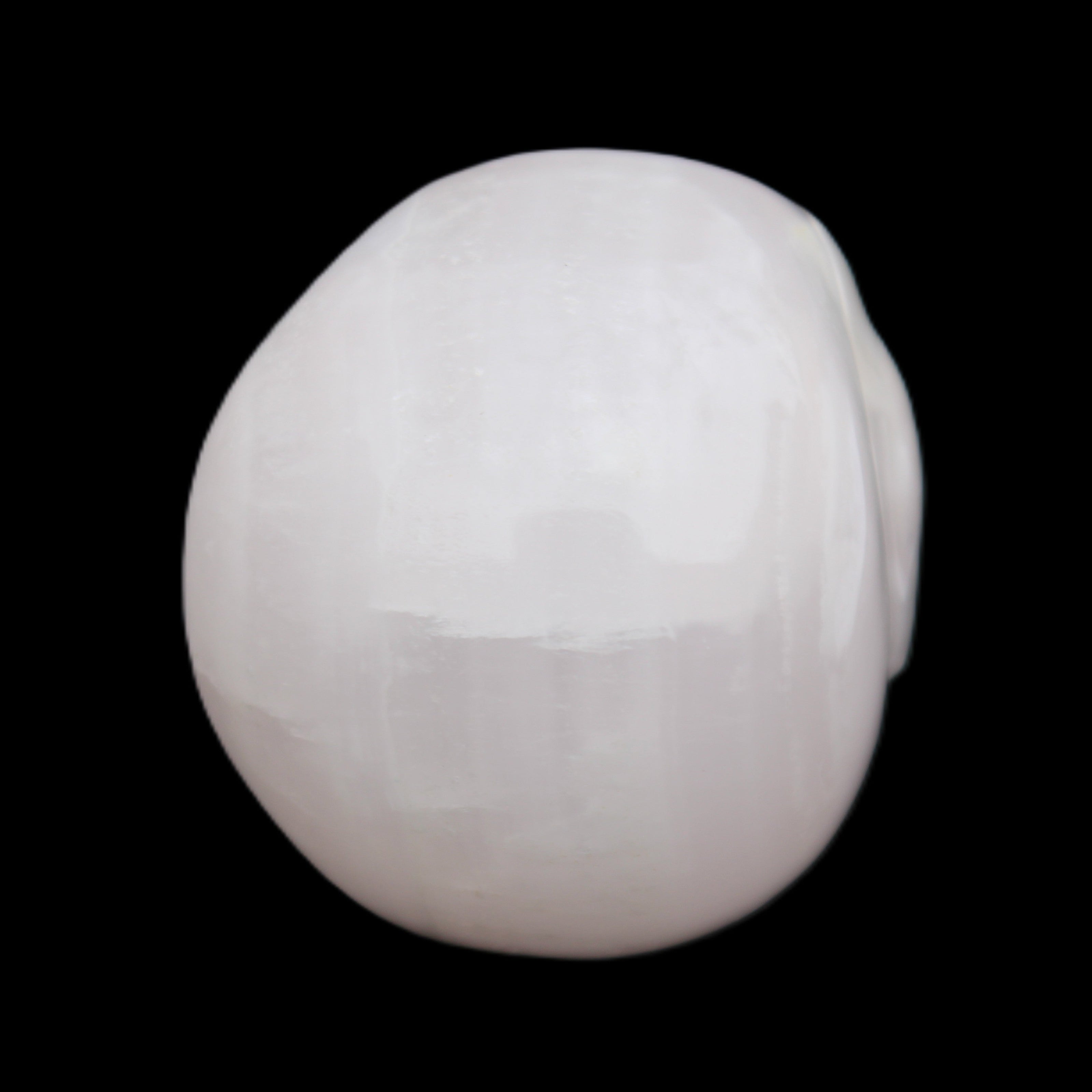Mangano Calcite skull 45*60*57mm 199g in sunlight - Rocks and Things Store