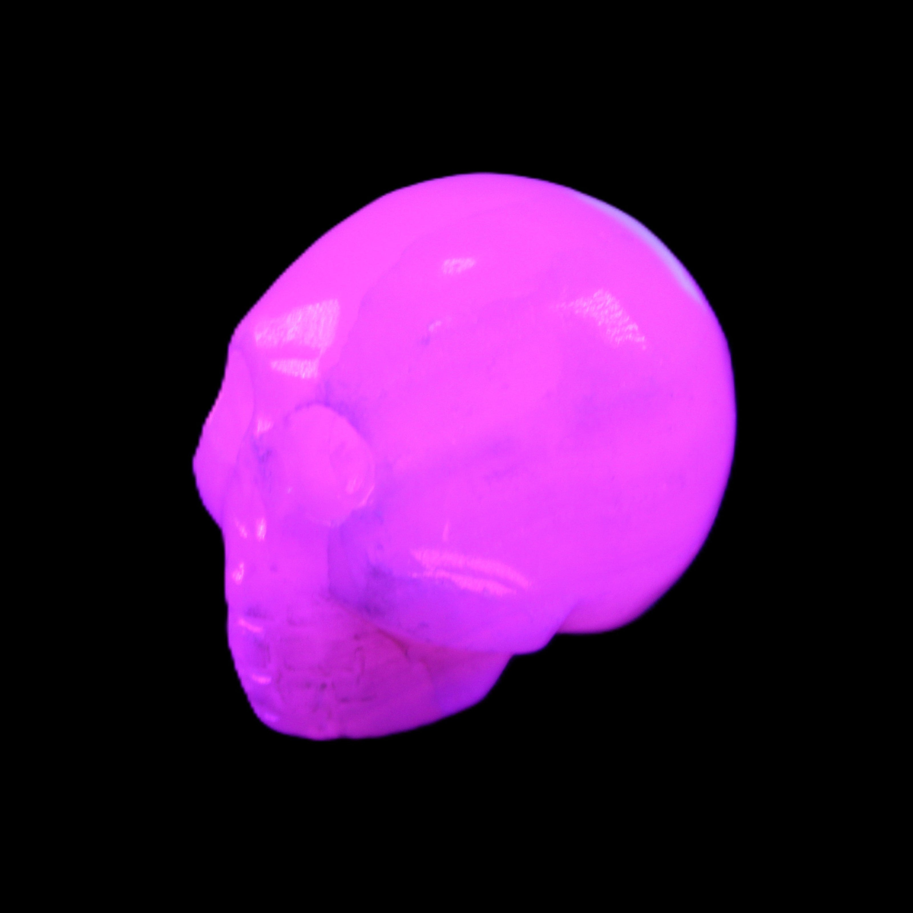 Mangano Calcite skull 30*42*35mm 77g in UV light - Rocks and Things Store