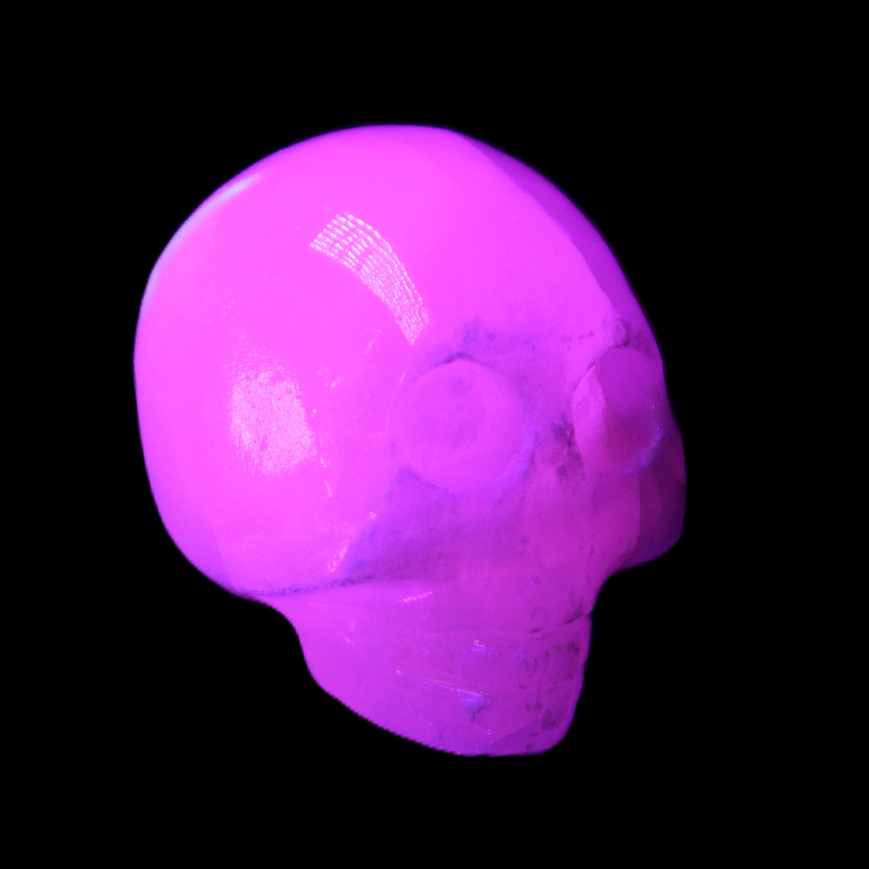 Mangano Calcite skull 30*42*35mm 77g in UV light - Rocks and Things Store