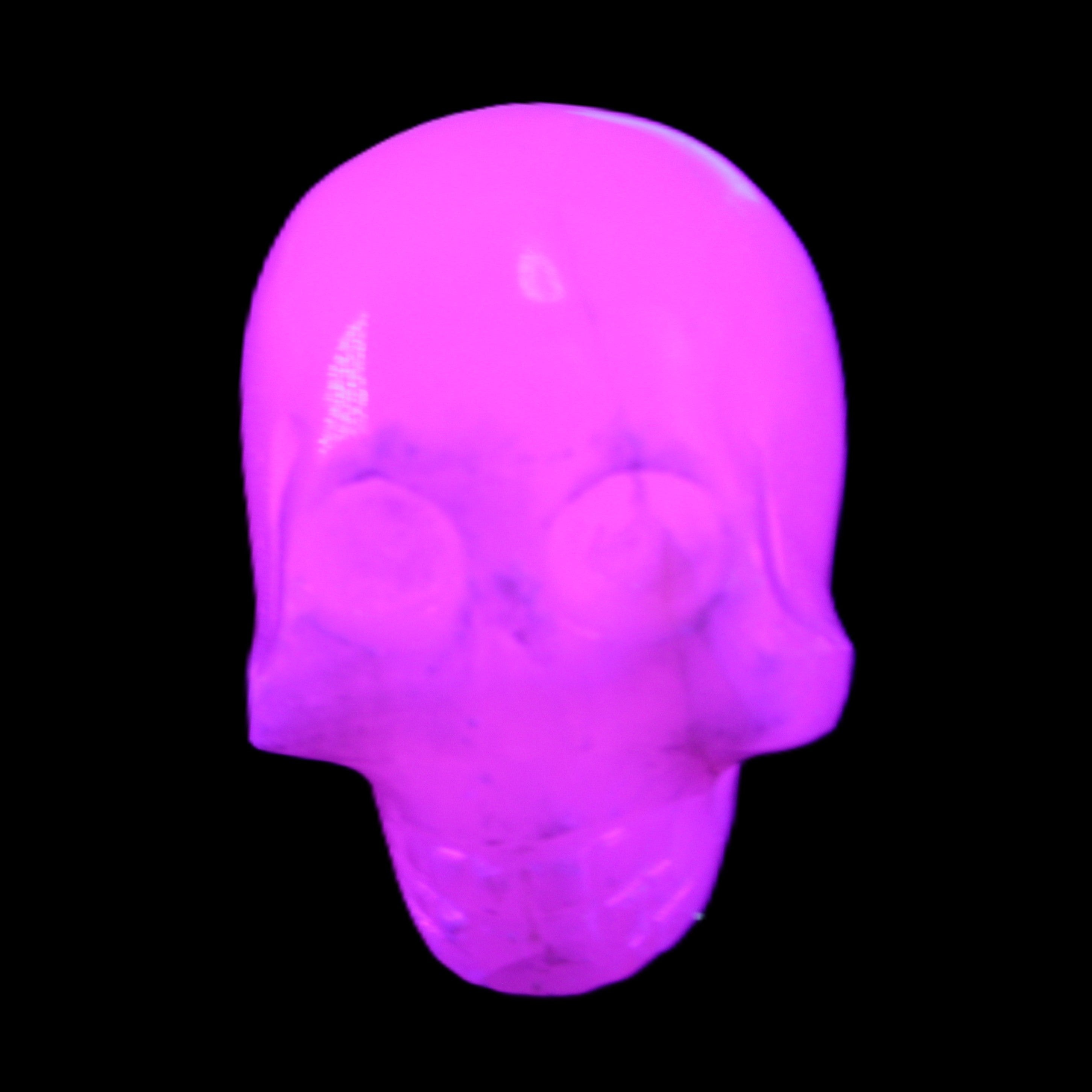 Mangano Calcite skull 30*42*35mm 77g in UV light - Rocks and Things Store