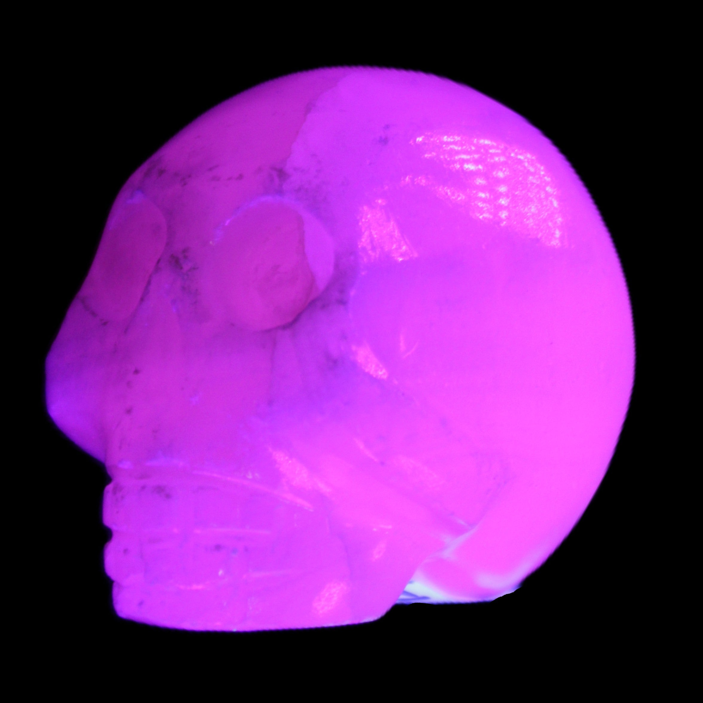 Mangano Calcite skull 30*42*35mm 77g in UV light - Rocks and Things Store