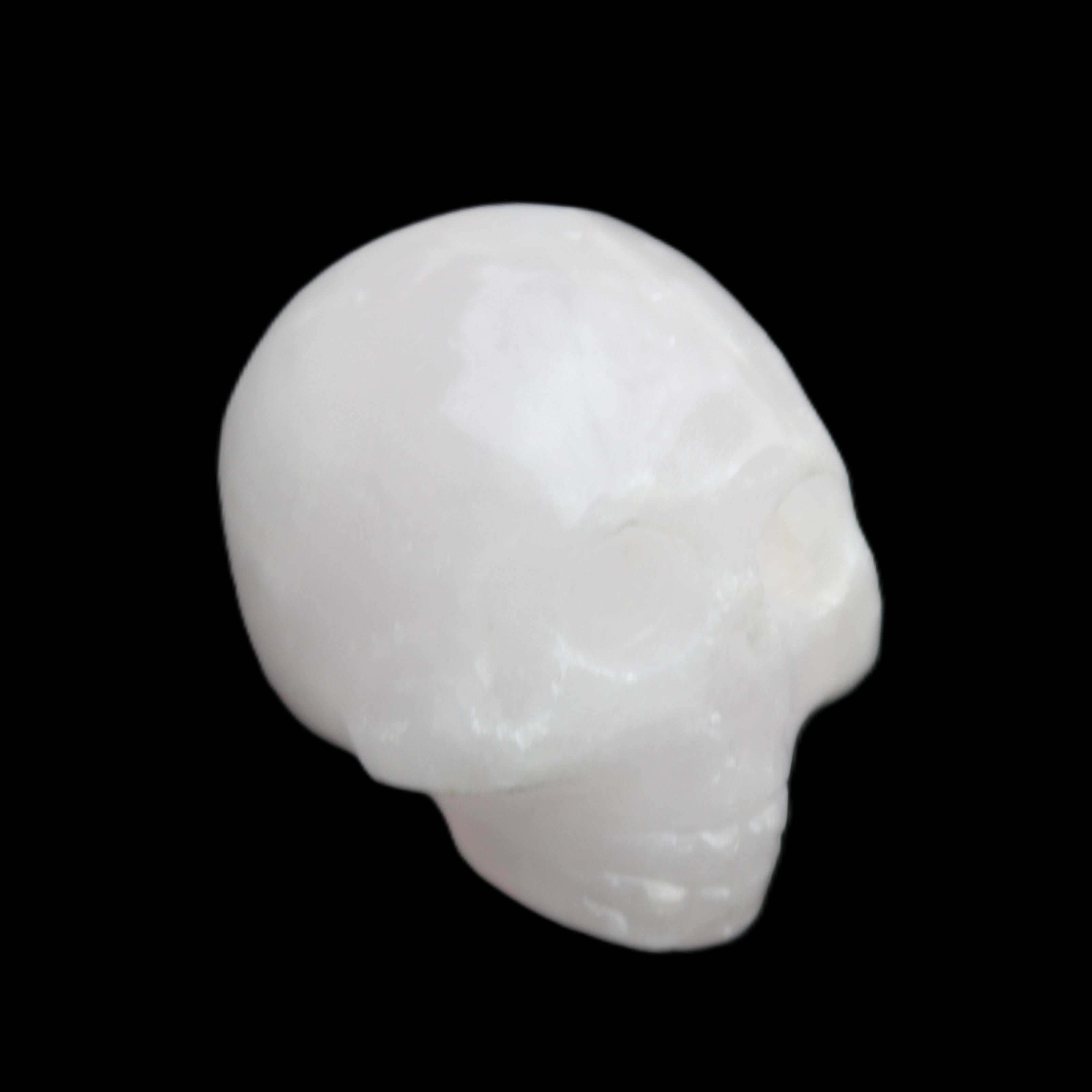 Mangano Calcite skull 30*42*35mm 77g in sunlight - Rocks and Things Store