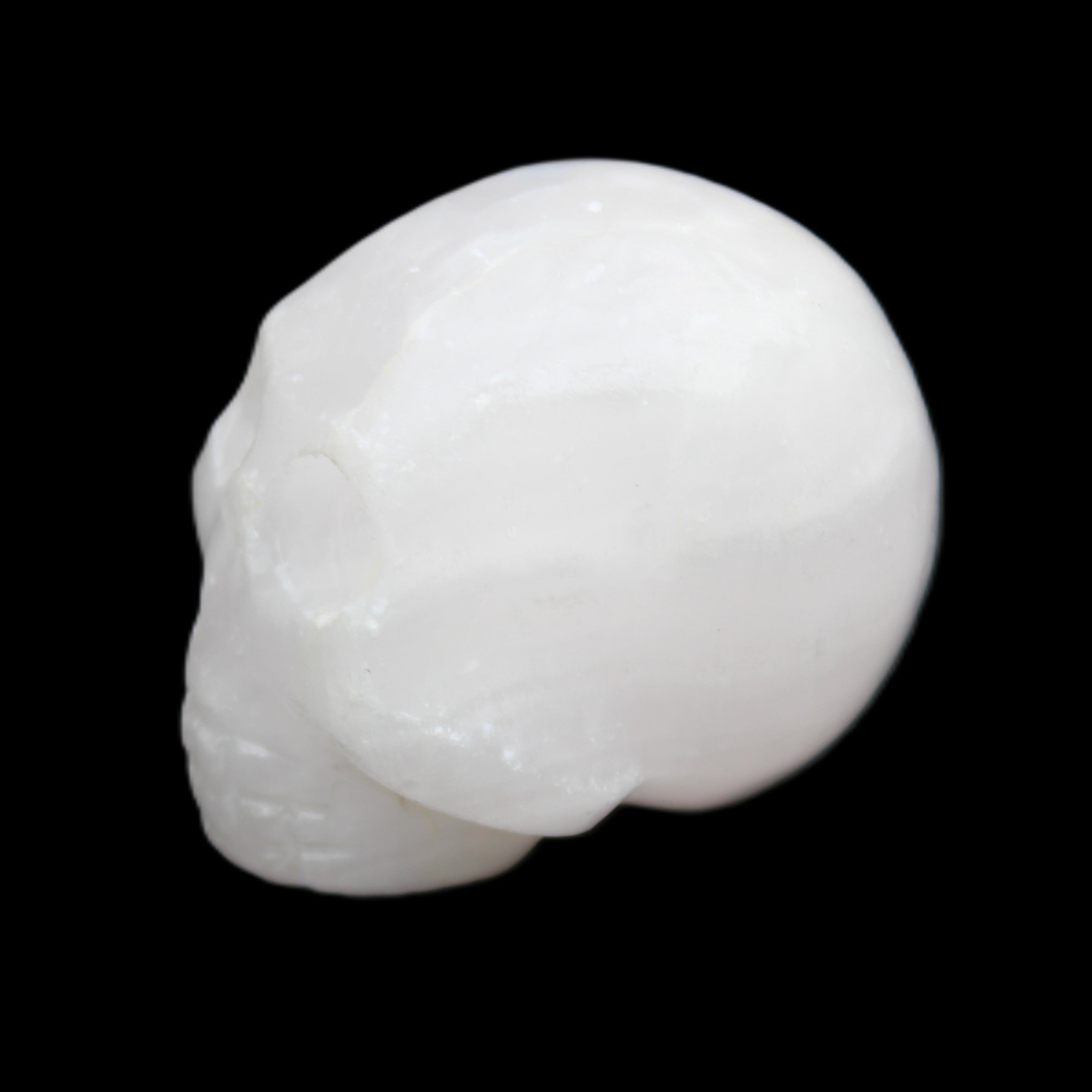 Mangano Calcite skull 30*42*35mm 77g in sunlight - Rocks and Things Store