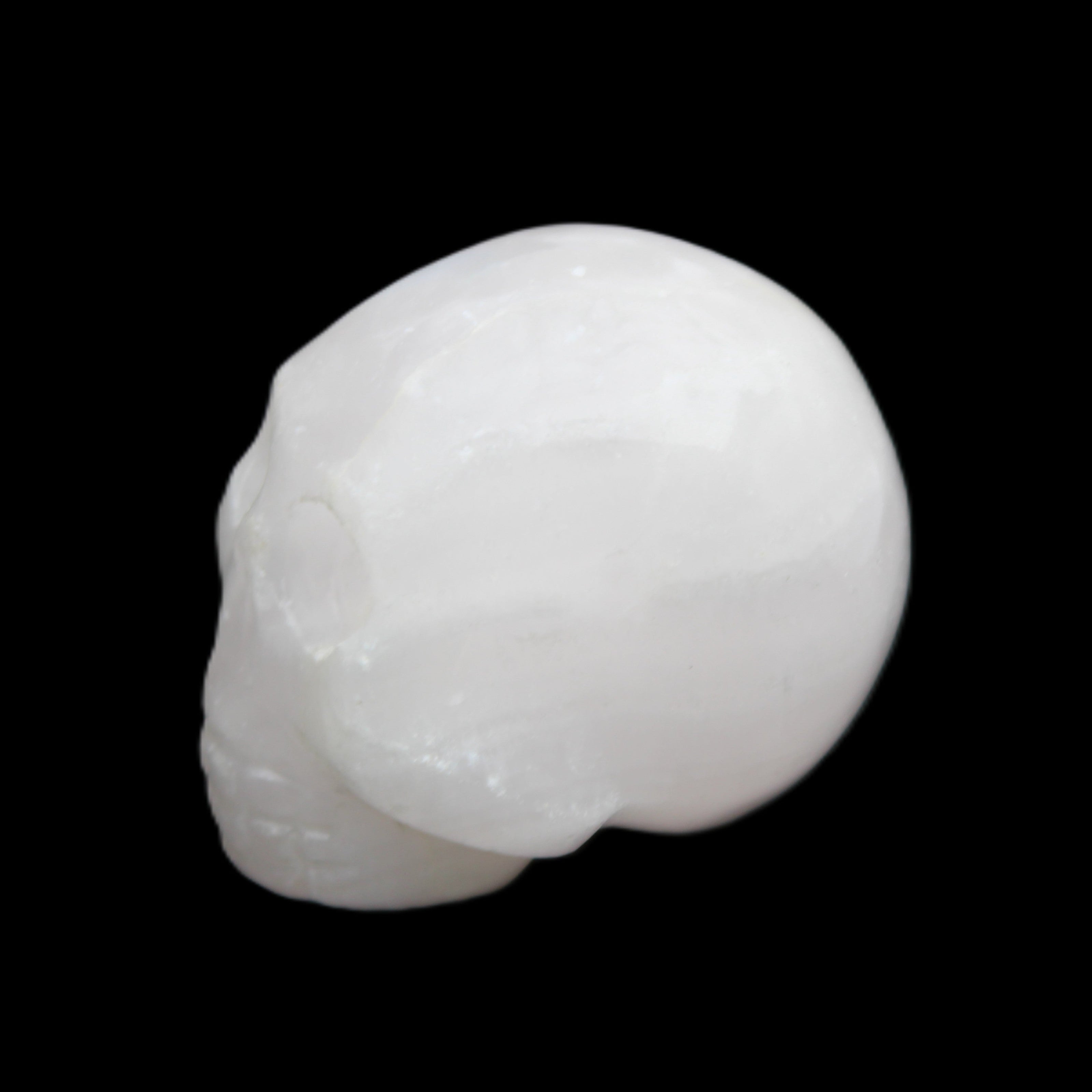 Mangano Calcite skull 30*42*35mm 77g in sunlight - Rocks and Things Store