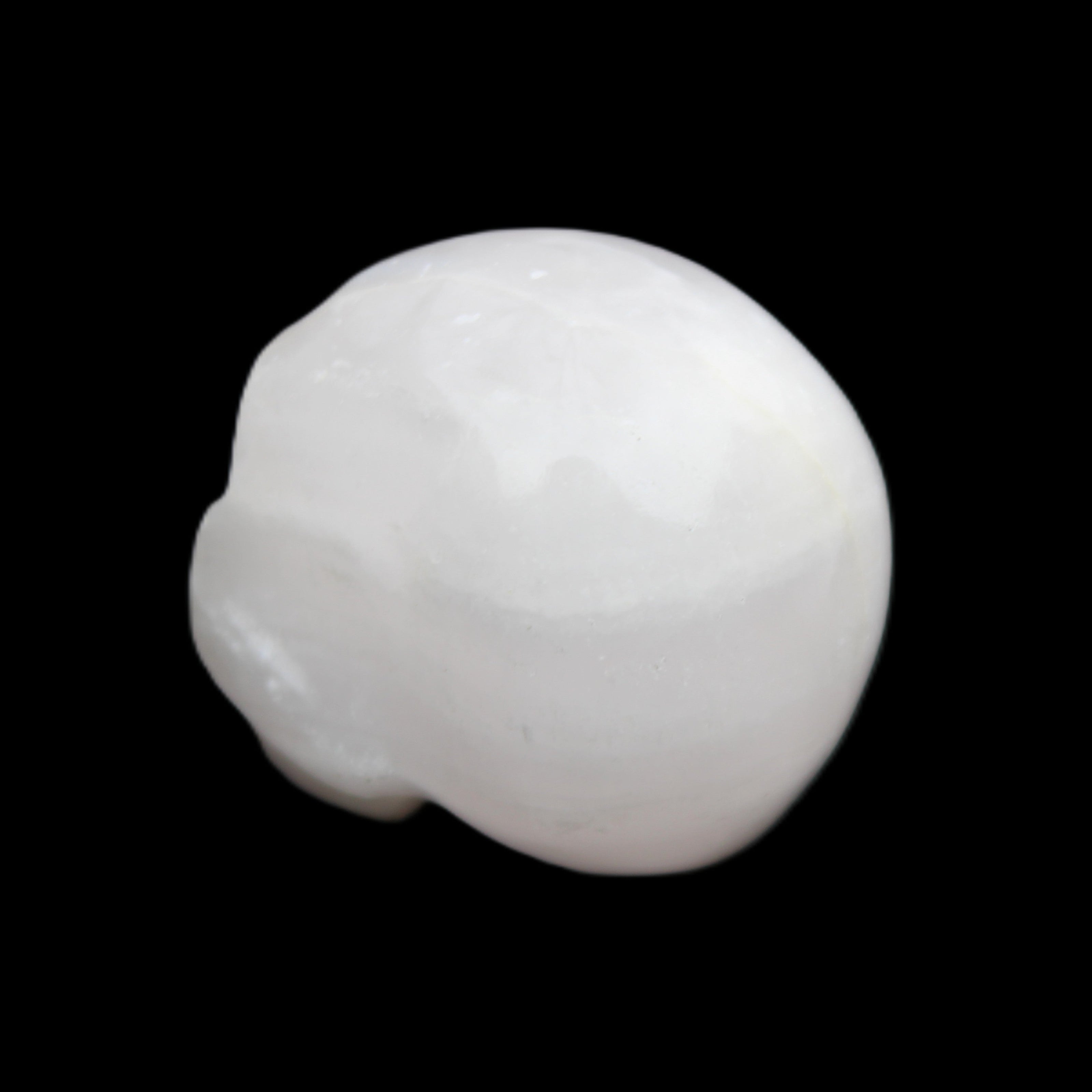 Mangano Calcite skull 30*42*35mm 77g in sunlight - Rocks and Things Store
