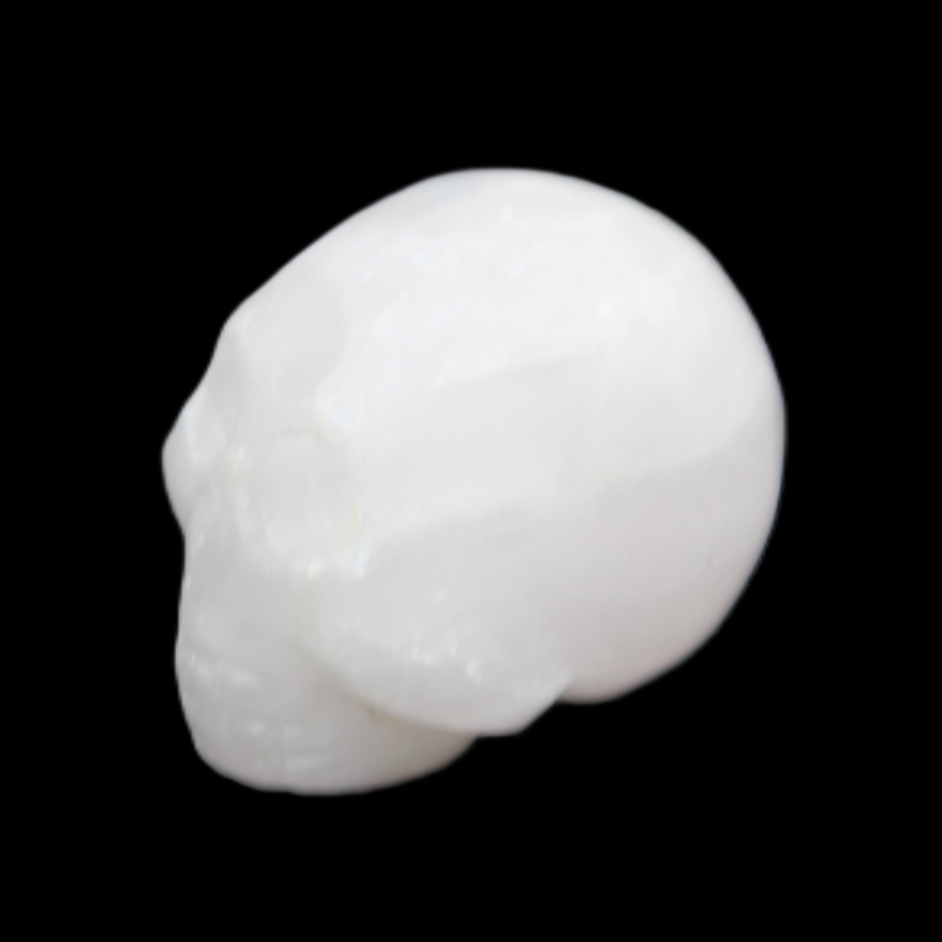 Mangano Calcite skull 30*42*35mm 77g in sunlight - Rocks and Things Store