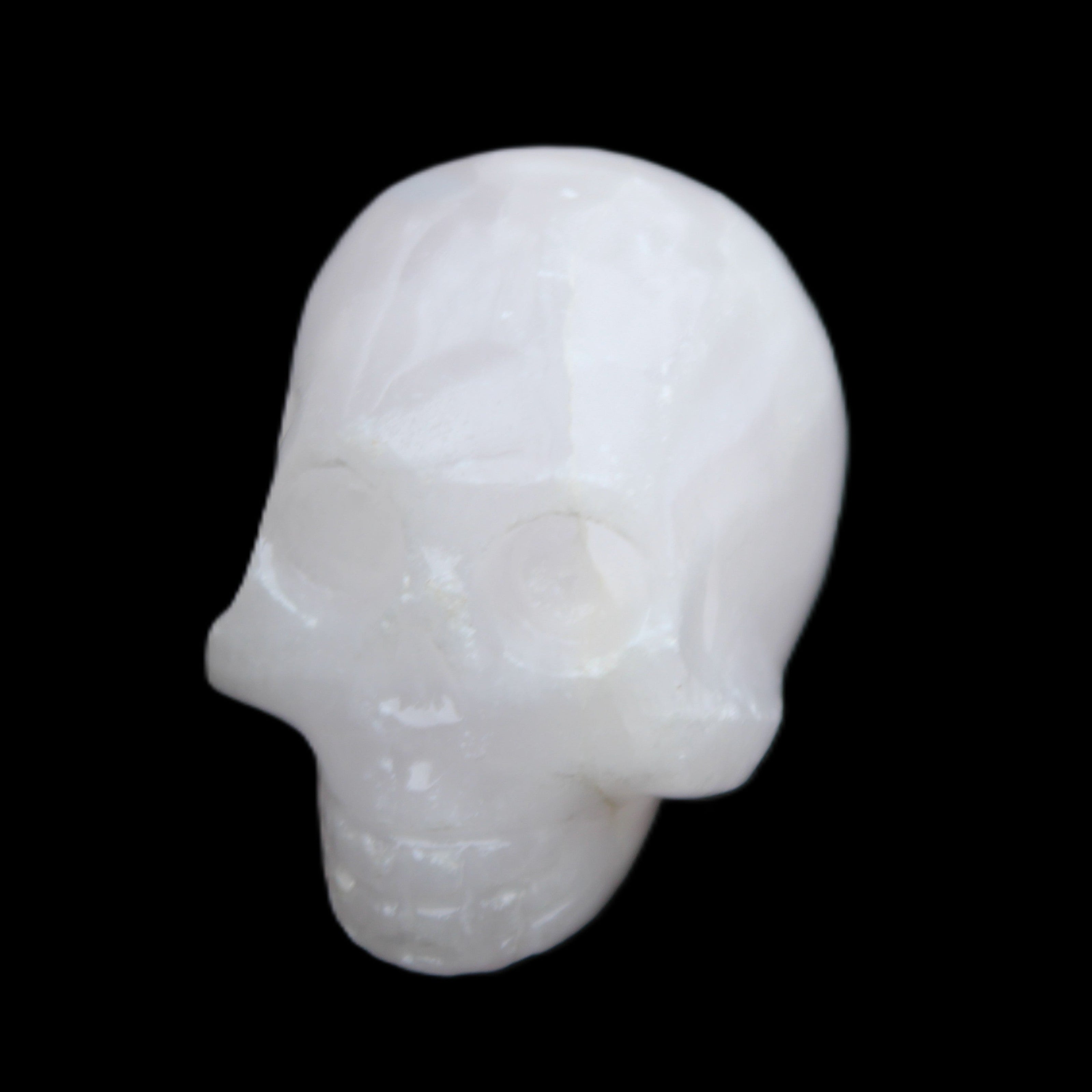 Mangano Calcite skull 30*42*35mm 77g in sunlight - Rocks and Things Store