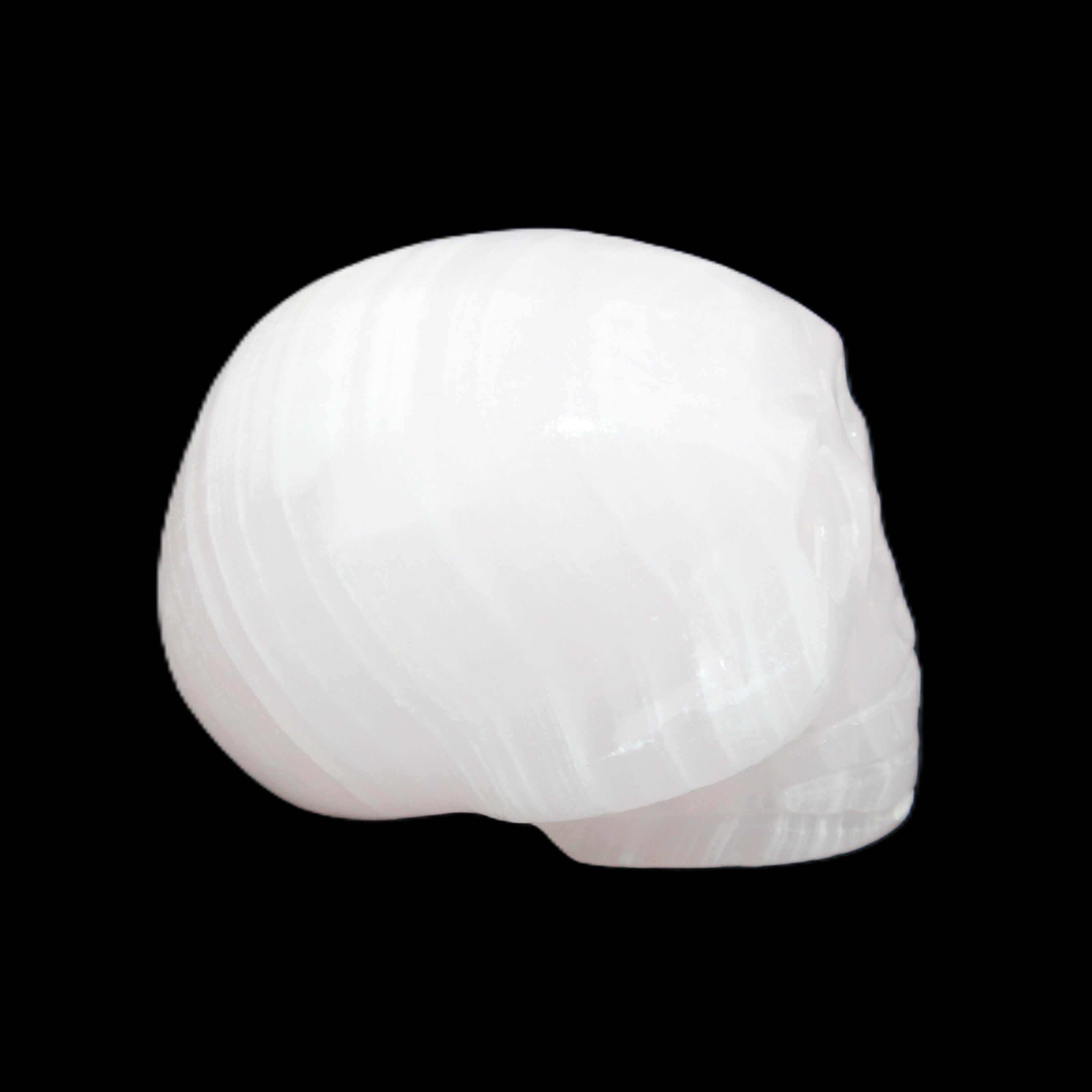 Mangano Calcite skull 30*47*36mm 85g in sunlight - Rocks and Things Store