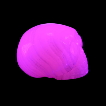 Mangano Calcite skull 30*47*36mm 85g in UV light - Rocks and Things Store