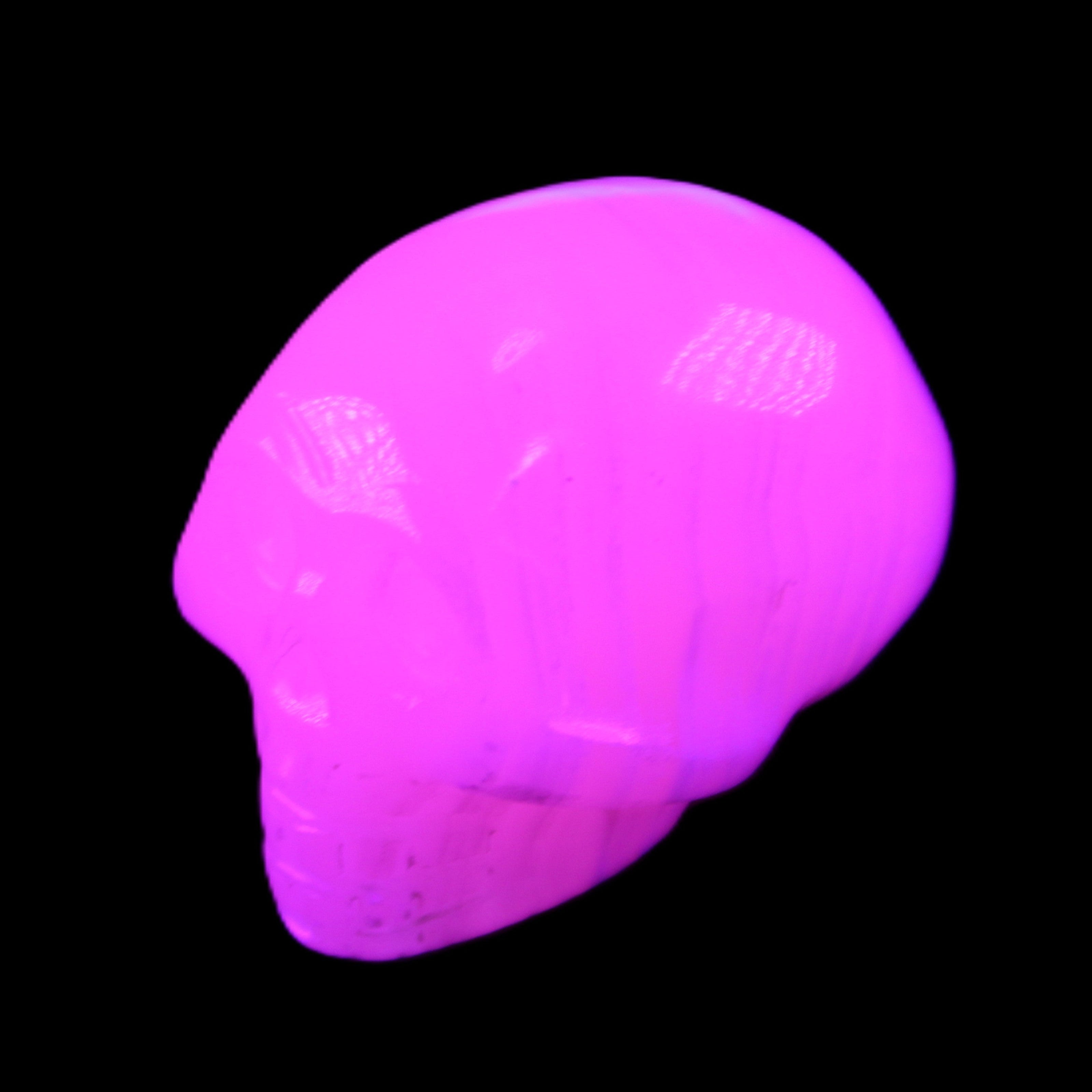 Mangano Calcite skull 30*47*36mm 85g in UV light - Rocks and Things Store