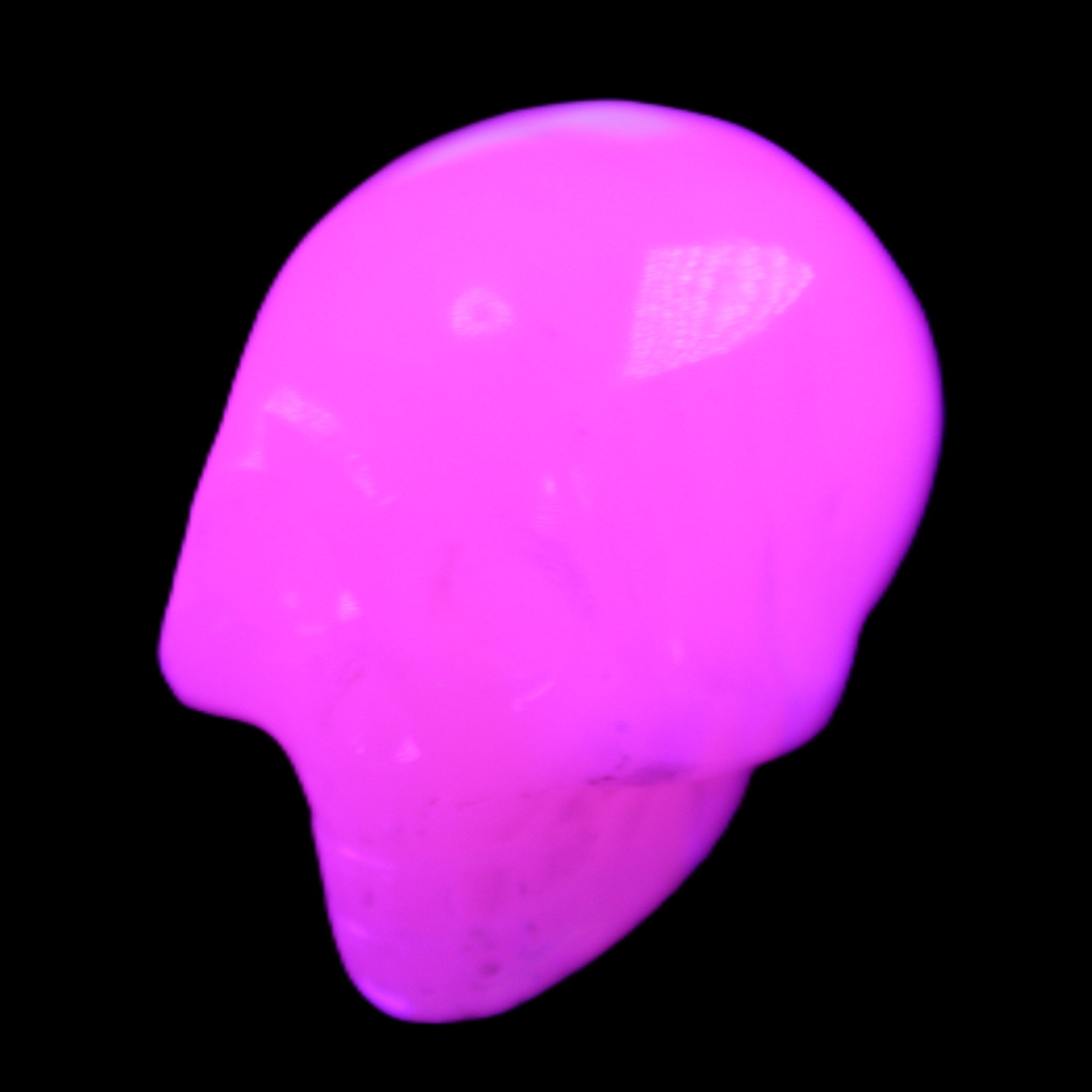 Mangano Calcite skull 30*47*36mm 85g in UV light - Rocks and Things Store