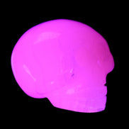 Mangano Calcite skull 30*47*36mm 85g in UV light - Rocks and Things Store