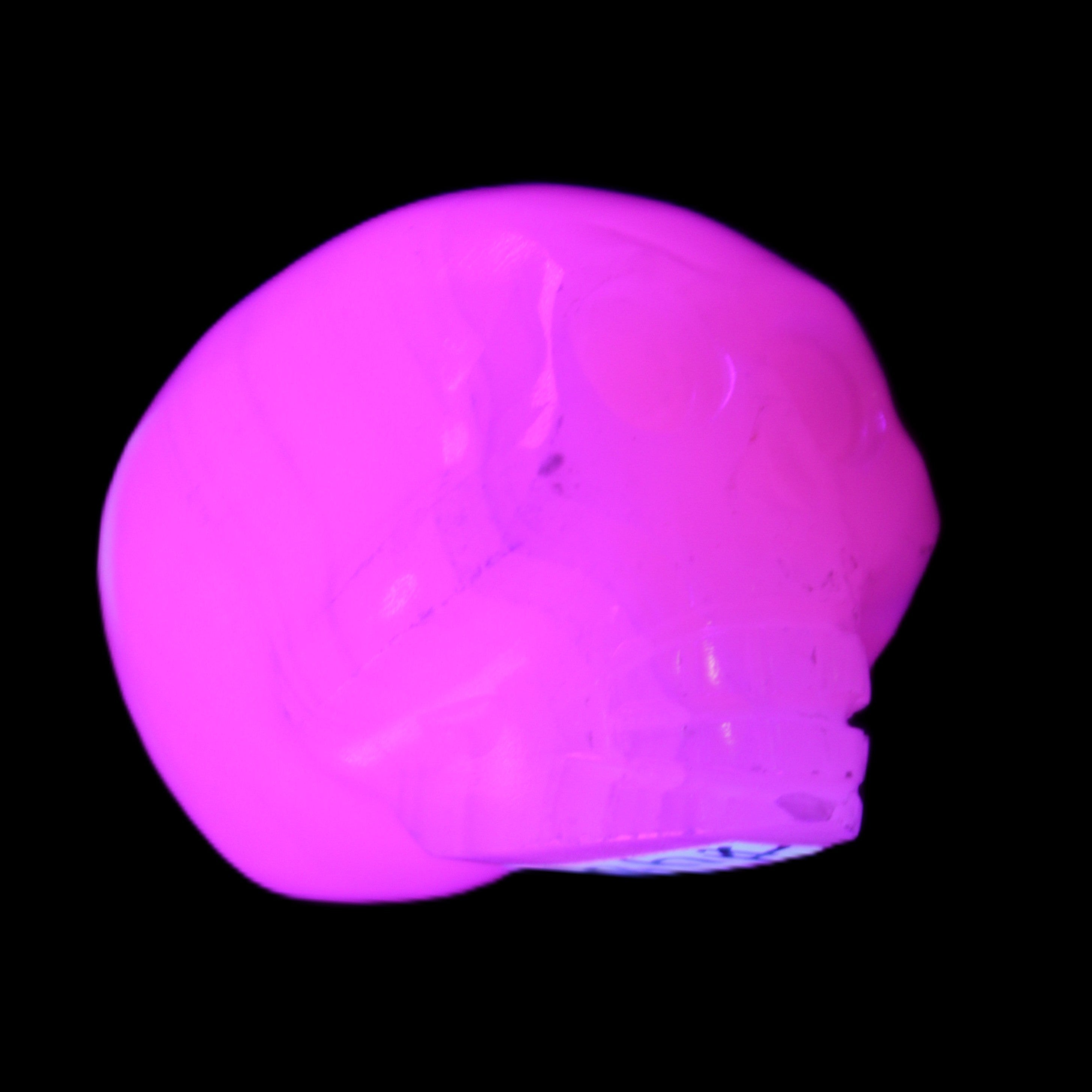 Mangano Calcite skull 30*47*36mm 85g in UV light - Rocks and Things Store