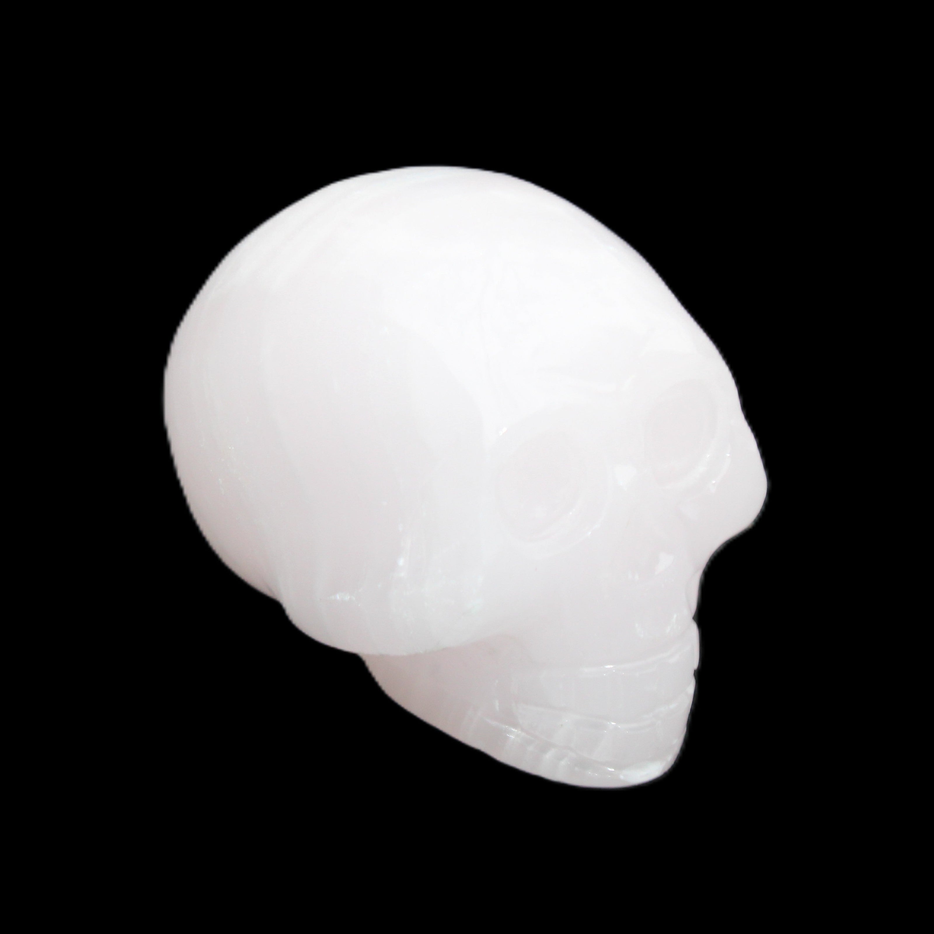 Mangano Calcite skull 30*47*36mm 85g in sunlight - Rocks and Things Store