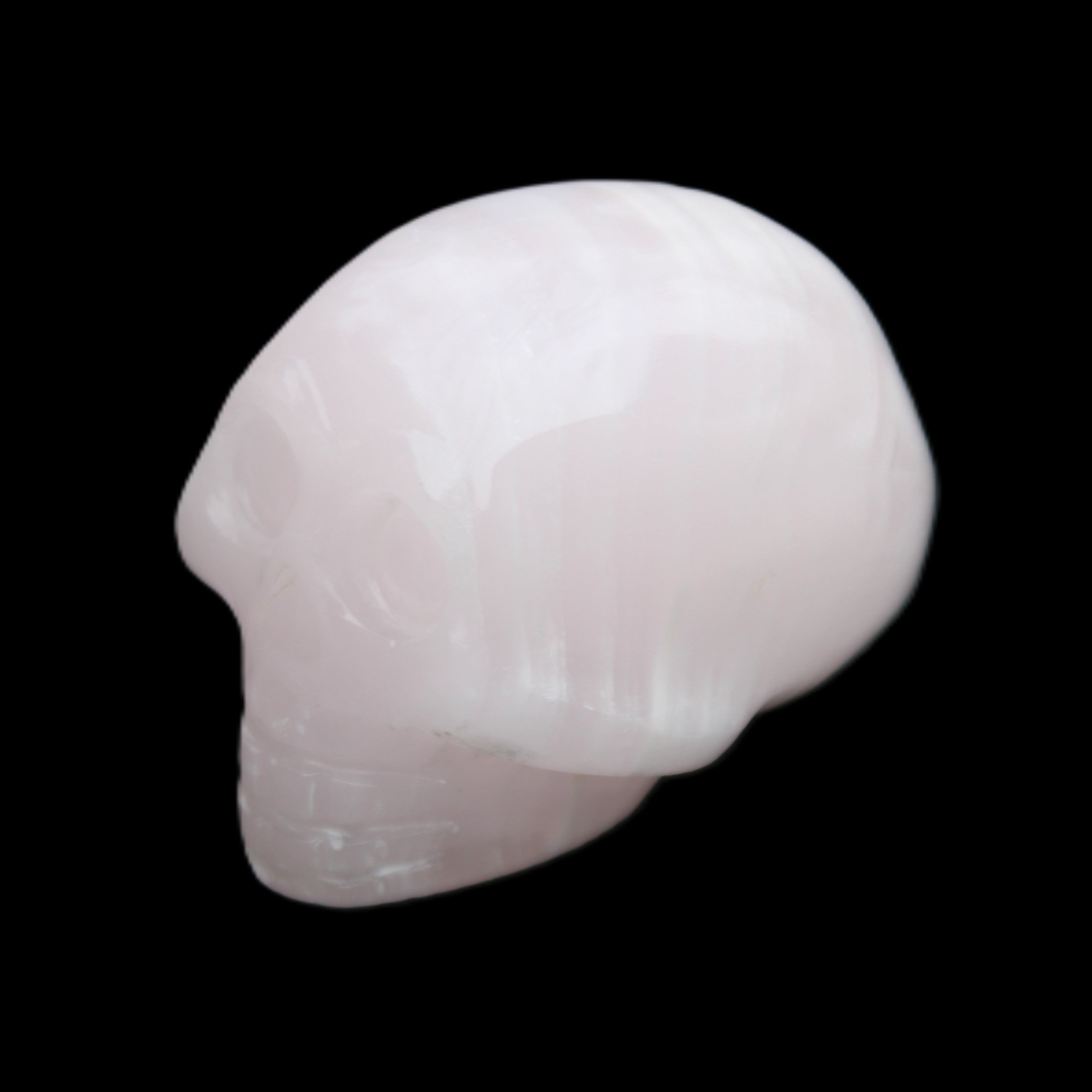 Mangano Calcite skull 30*47*36mm 85g in sunlight - Rocks and Things Store