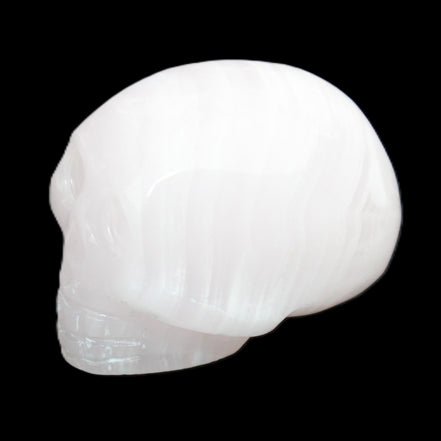Mangano Calcite skull 30*47*36mm 85g in sunlight - Rocks and Things Store