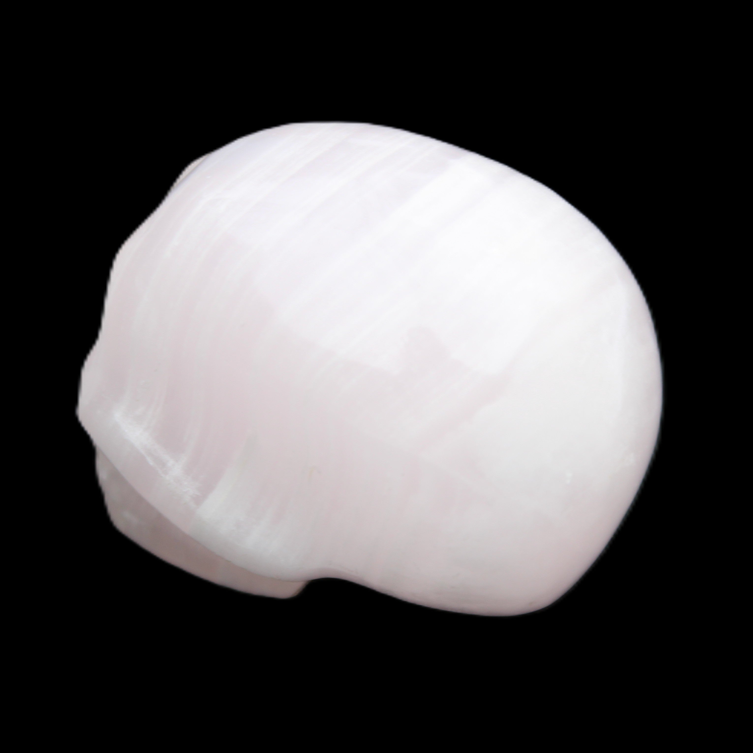 Mangano Calcite skull 30*47*36mm 85g in sunlight - Rocks and Things Store