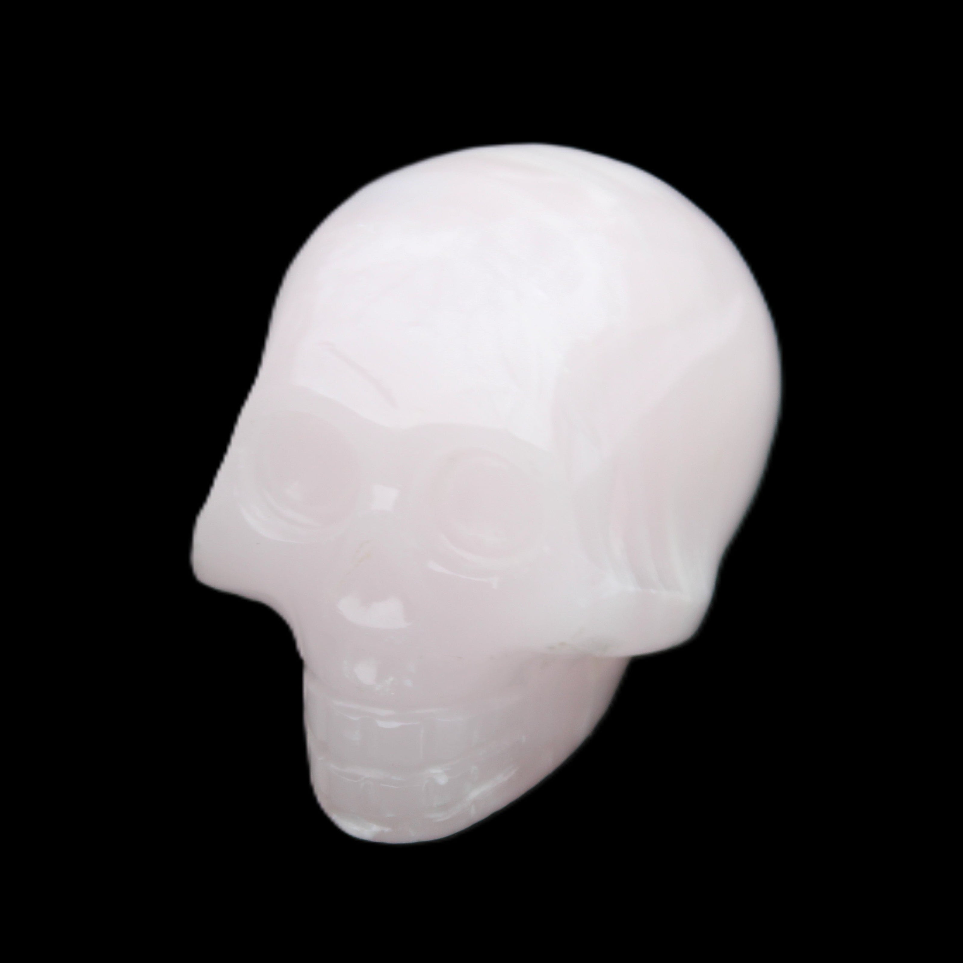 Mangano Calcite skull 30*47*36mm 85g in sunlight - Rocks and Things Store