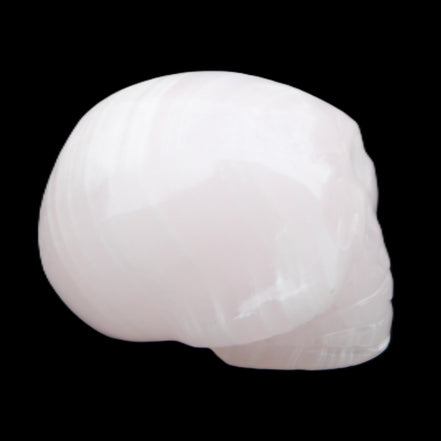 Mangano Calcite skull 30*47*36mm 85g in sunlight - Rocks and Things Store