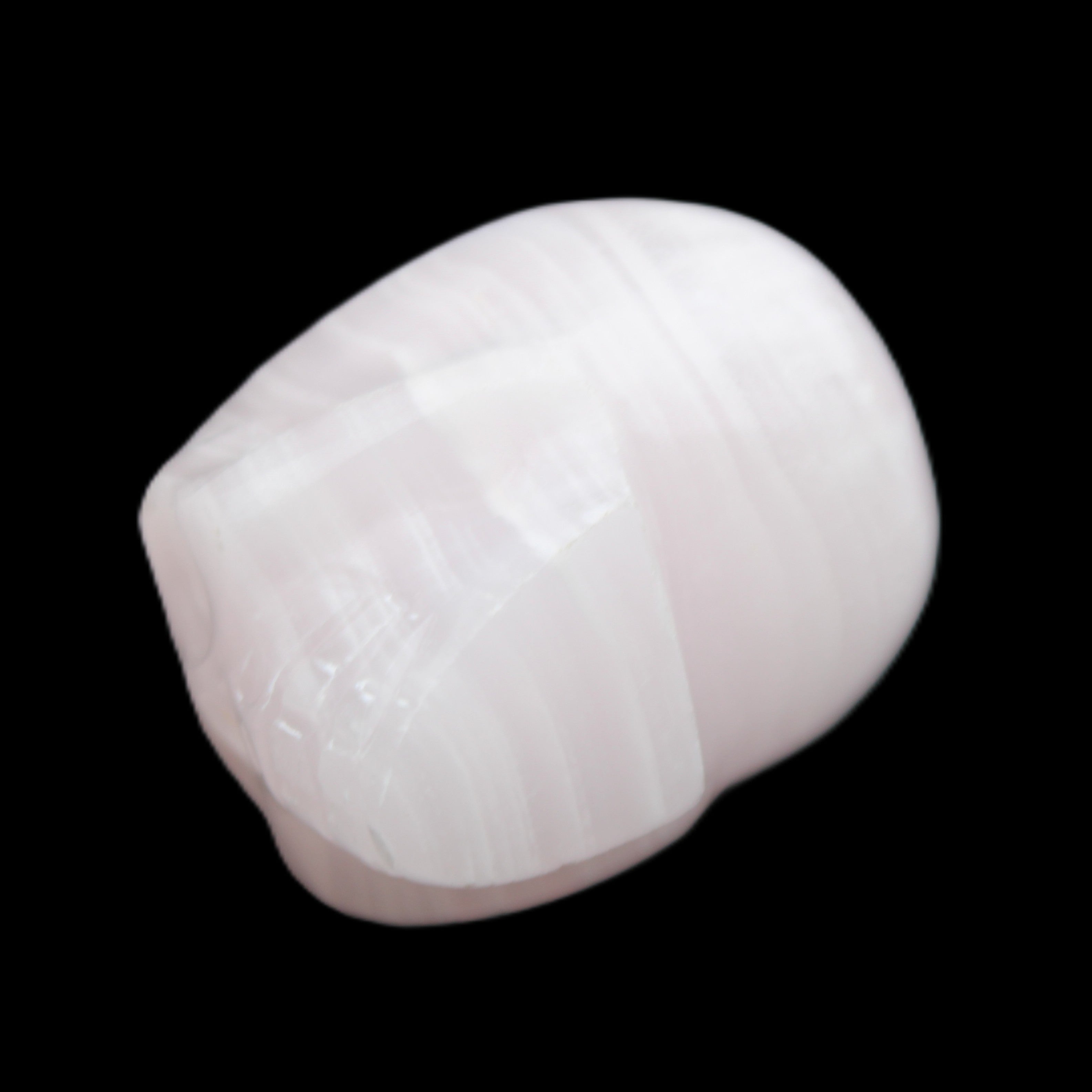 Mangano Calcite skull 30*47*36mm 85g in sunlight - Rocks and Things Store