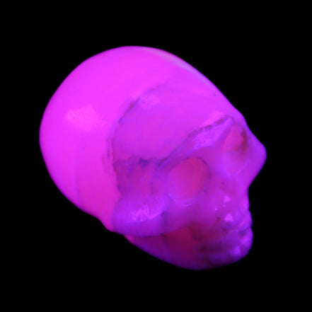 Mangano Calcite skull 31*46*36mm 83g in UV light - Rocks and Things Store