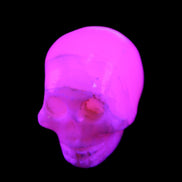 Mangano Calcite skull 31*46*36mm 83g in UV light - Rocks and Things Store