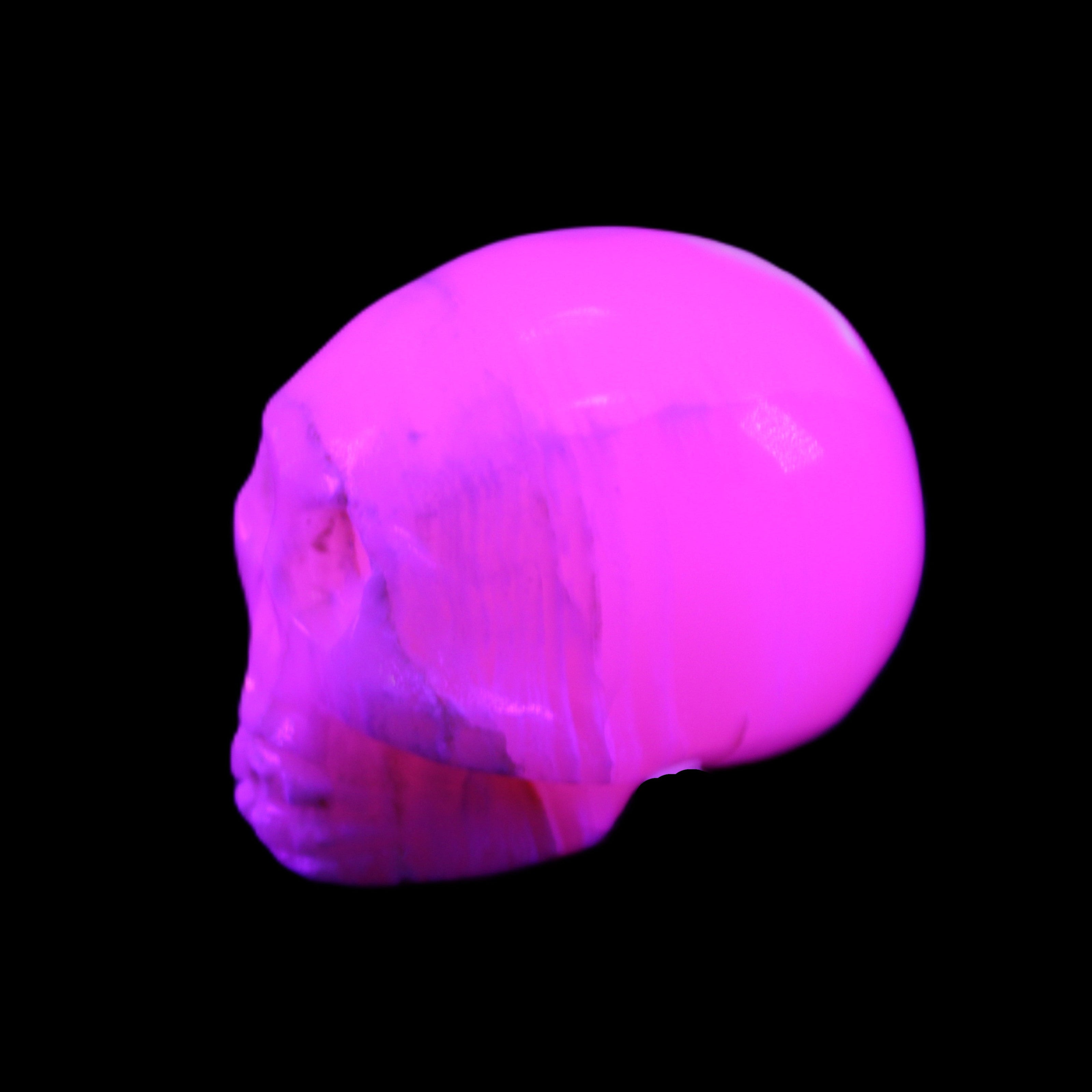 Mangano Calcite skull 31*46*36mm 83g in UV light - Rocks and Things Store