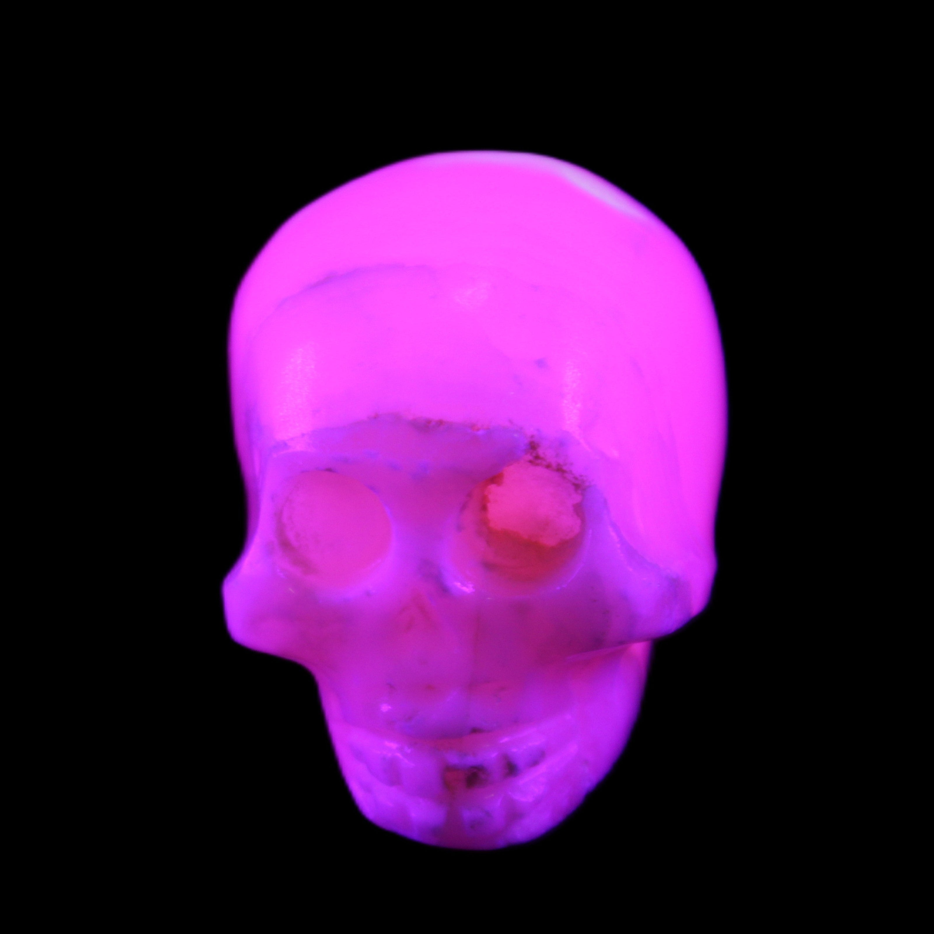 Mangano Calcite skull 31*46*36mm 83g in UV light - Rocks and Things Store