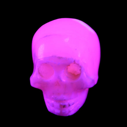 Mangano Calcite skull 31*46*36mm 83g in UV light - Rocks and Things Store
