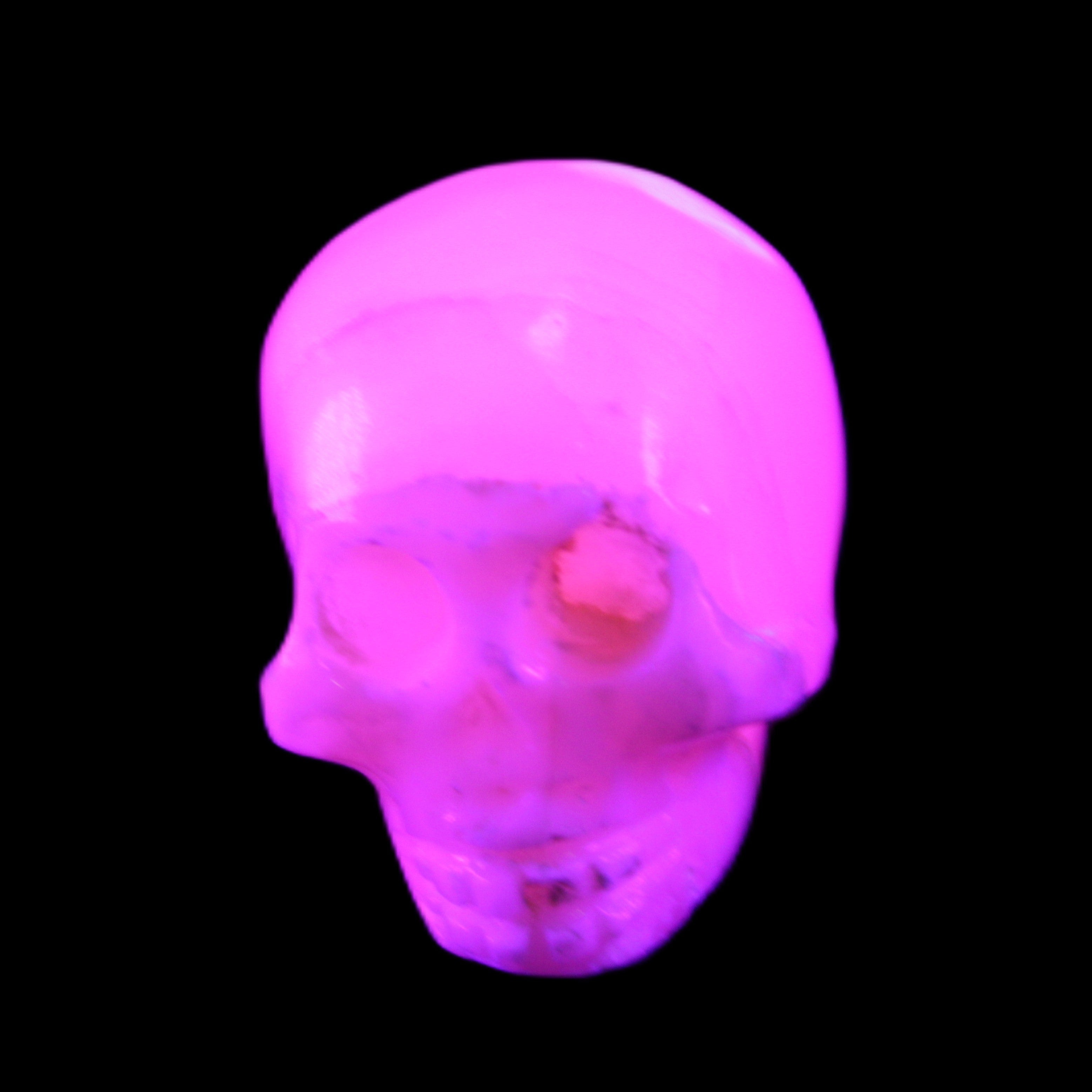 Mangano Calcite skull 31*46*36mm 83g in UV light - Rocks and Things Store