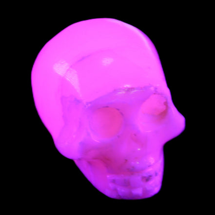 Mangano Calcite skull 31*46*36mm 83g in UV light - Rocks and Things Store