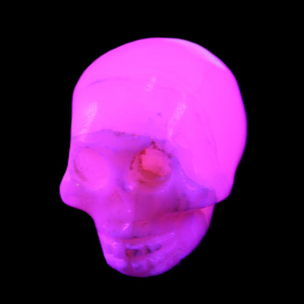 Mangano Calcite skull 31*46*36mm 83g in UV light - Rocks and Things Store