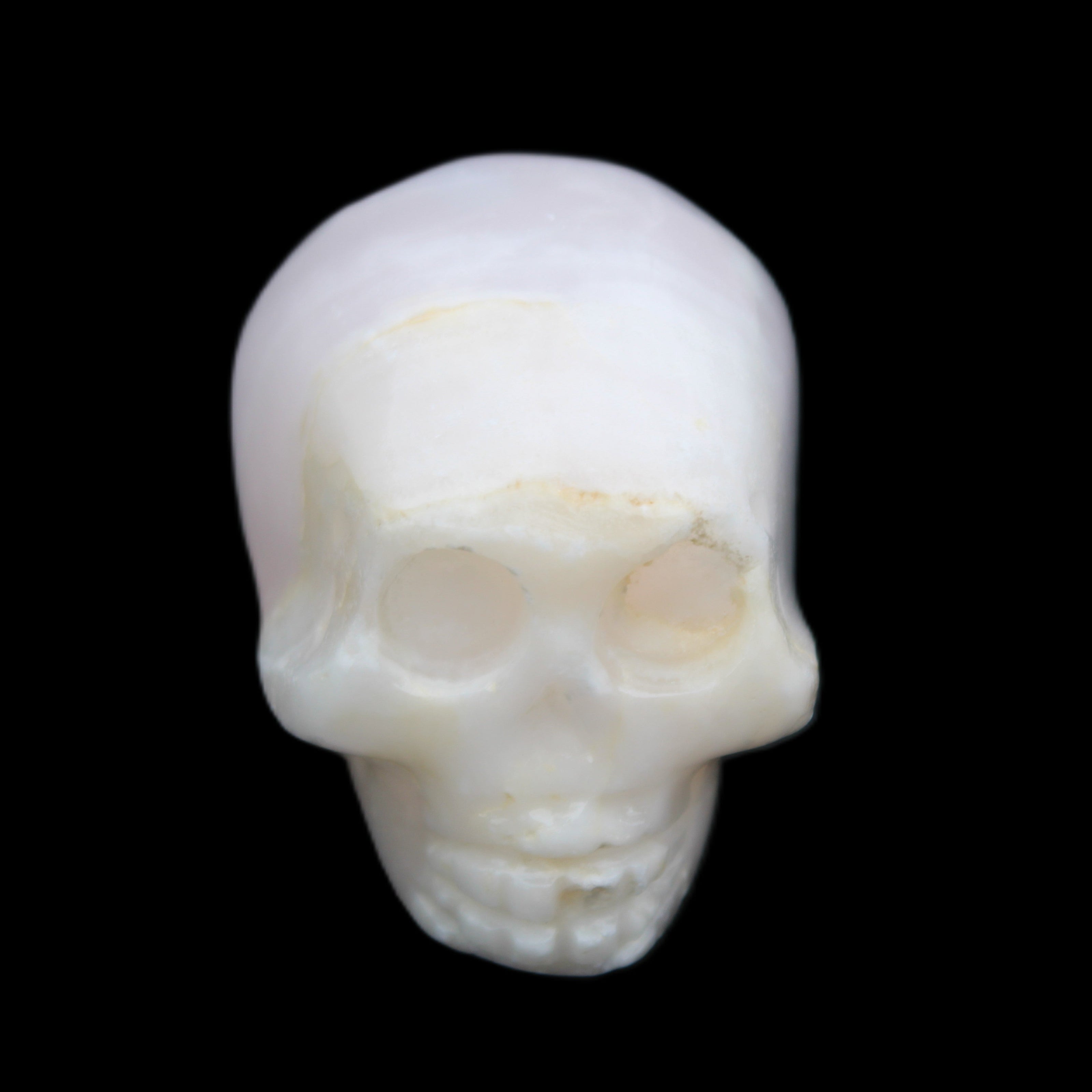 Mangano Calcite skull 31*46*36mm 83g in sunlight - Rocks and Things Store