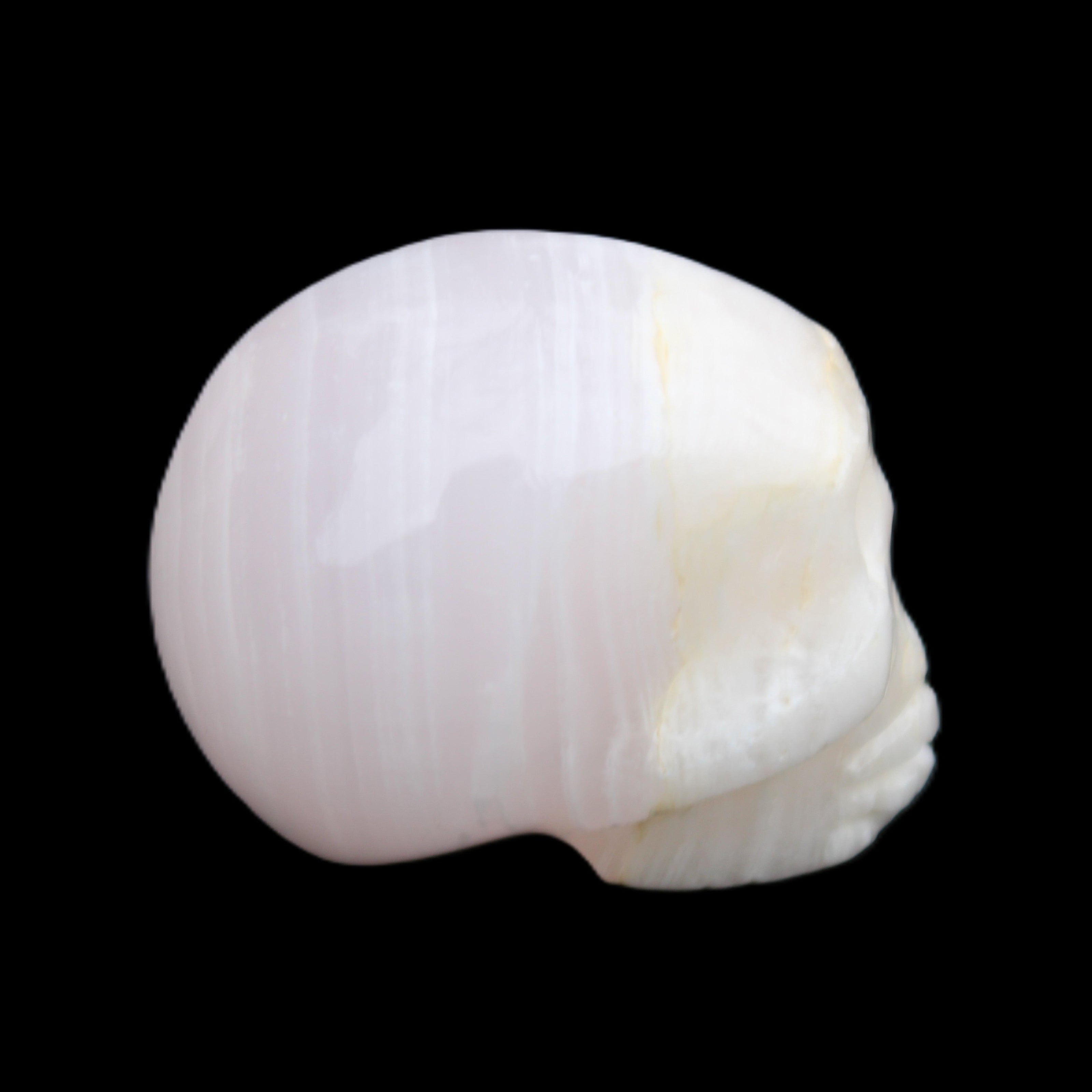 Mangano Calcite skull 31*46*36mm 83g in sunlight - Rocks and Things Store