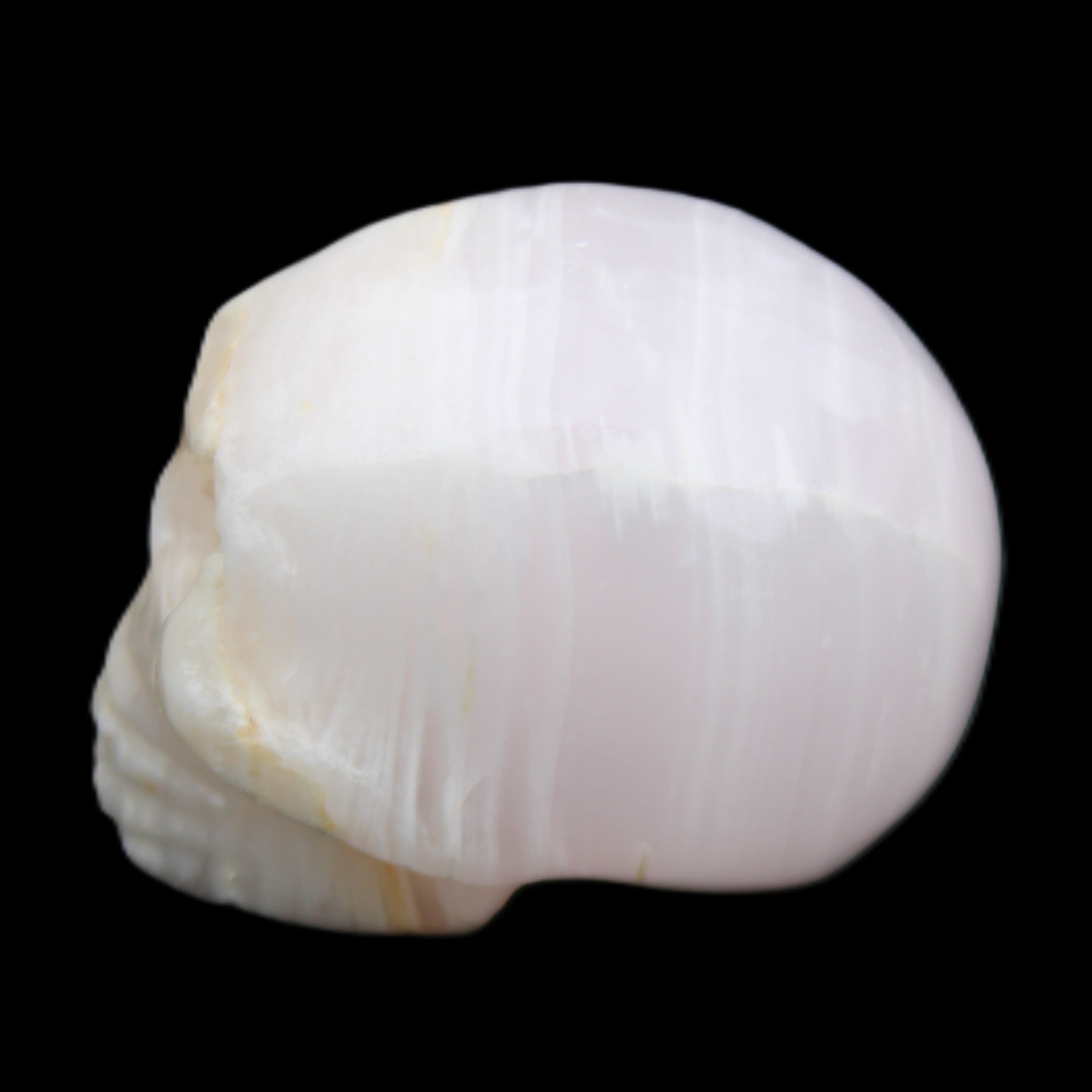 Mangano Calcite skull 31*46*36mm 83g in sunlight - Rocks and Things Store